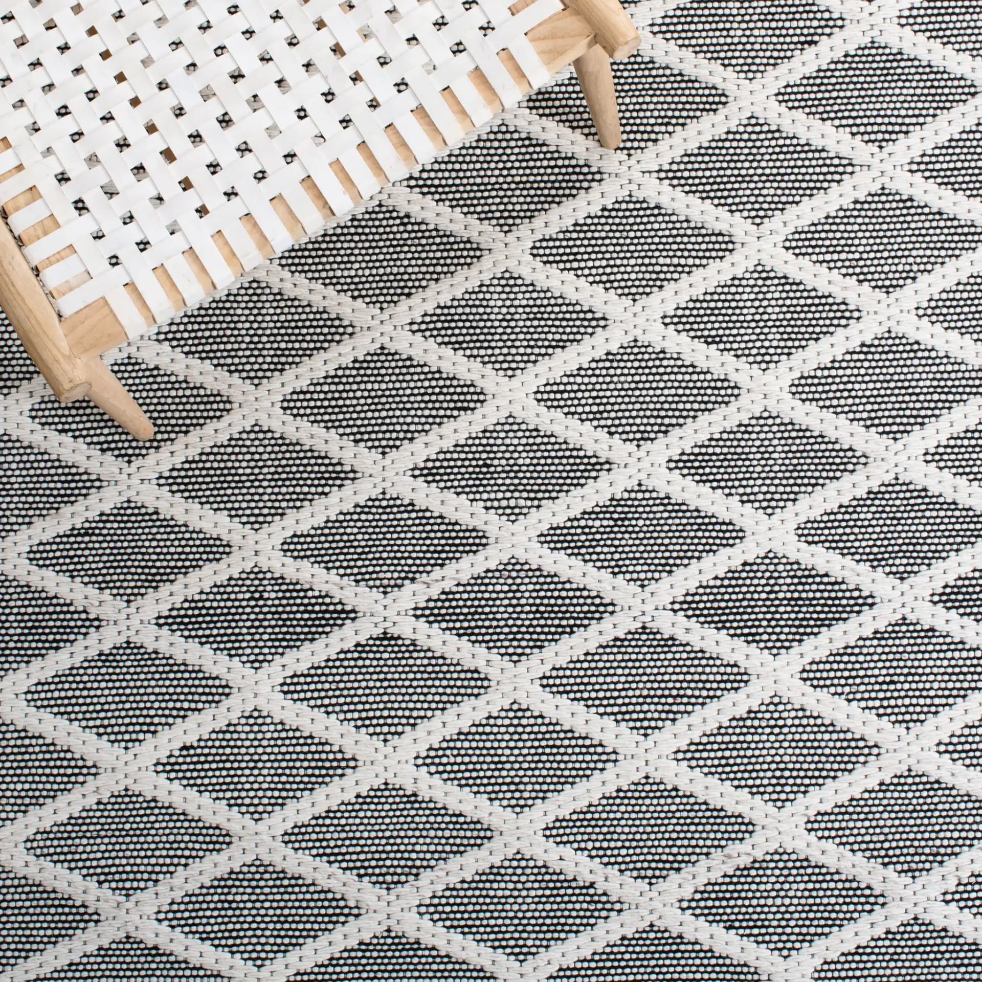 Marbella Banded Diamond Lattice Hand-Woven Wool Rug in Ivory / Black in a styled room