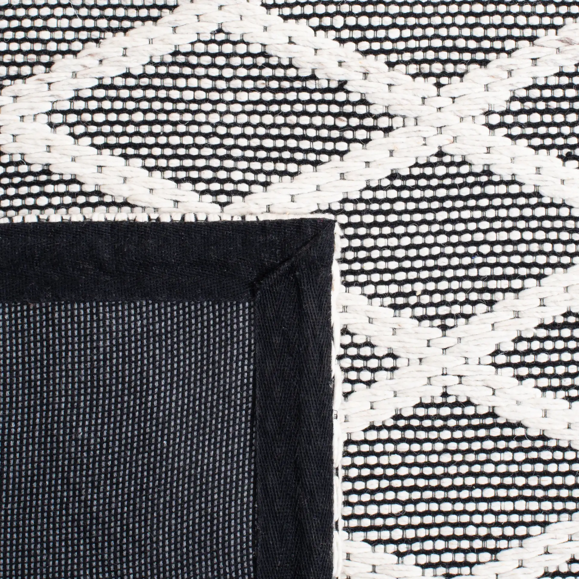 Marbella Banded Diamond Lattice Hand-Woven Wool Rug in Ivory / Black in a styled room
