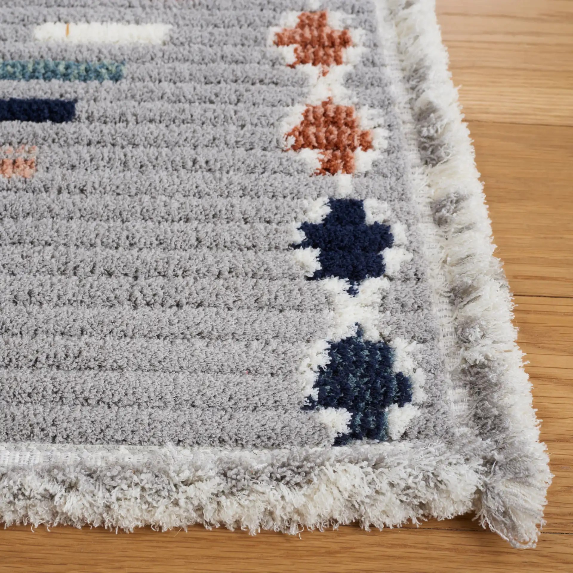 Marrakesh Dashed Diamond Rug in Gray / Blue Rust in a styled room