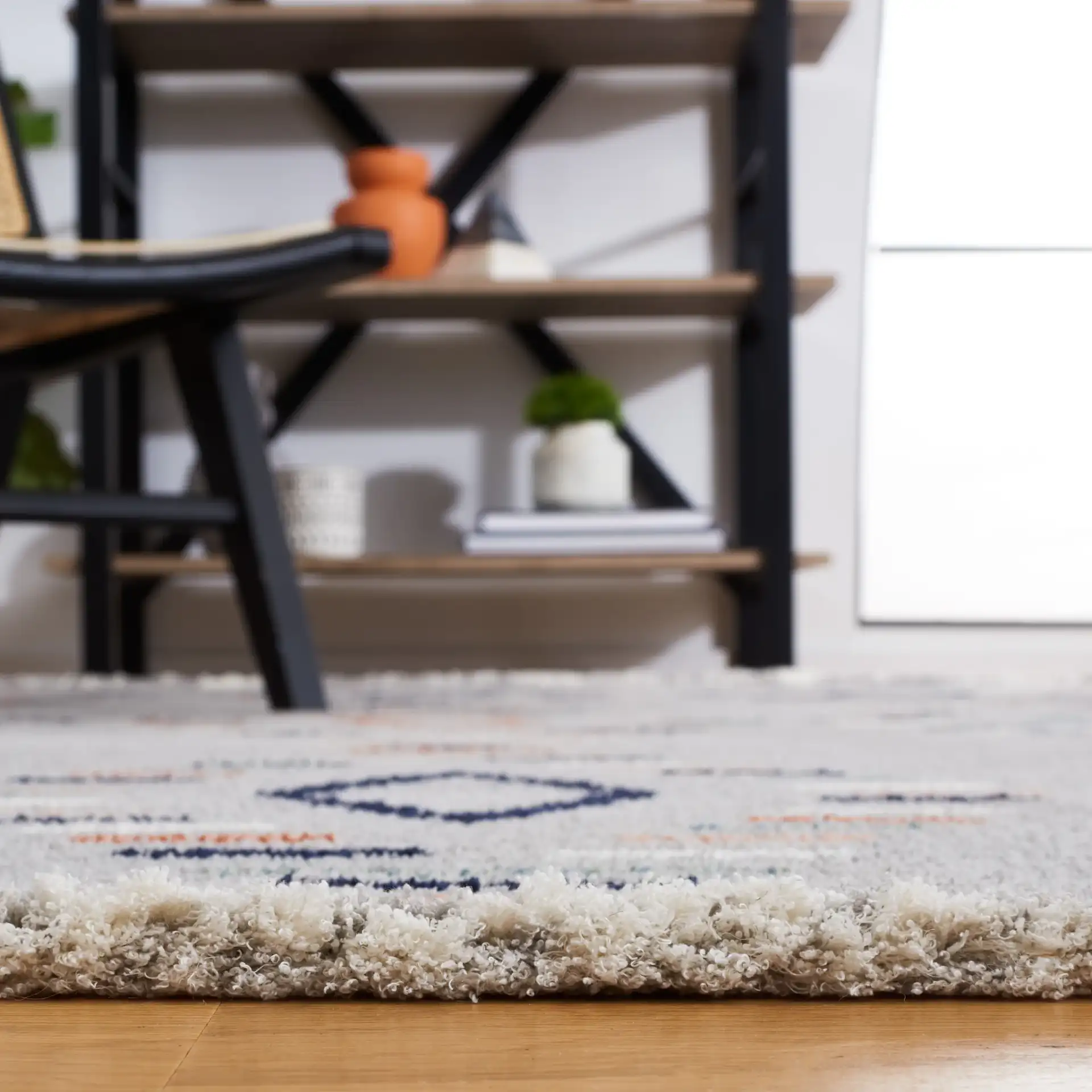 Marrakesh Dashed Diamond Rug in Gray / Blue Rust in a styled room