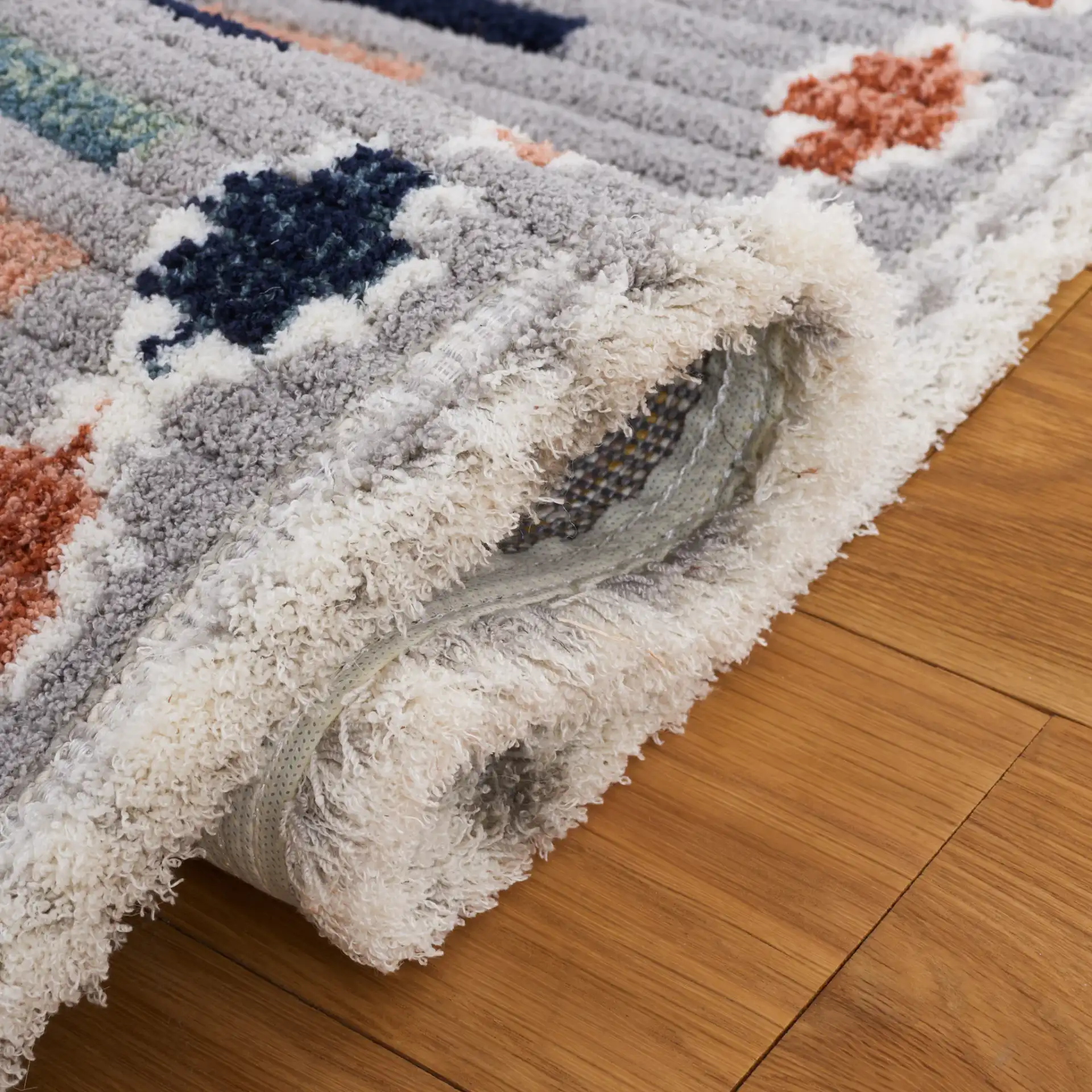 Marrakesh Dashed Diamond Rug in Gray / Blue Rust in a styled room