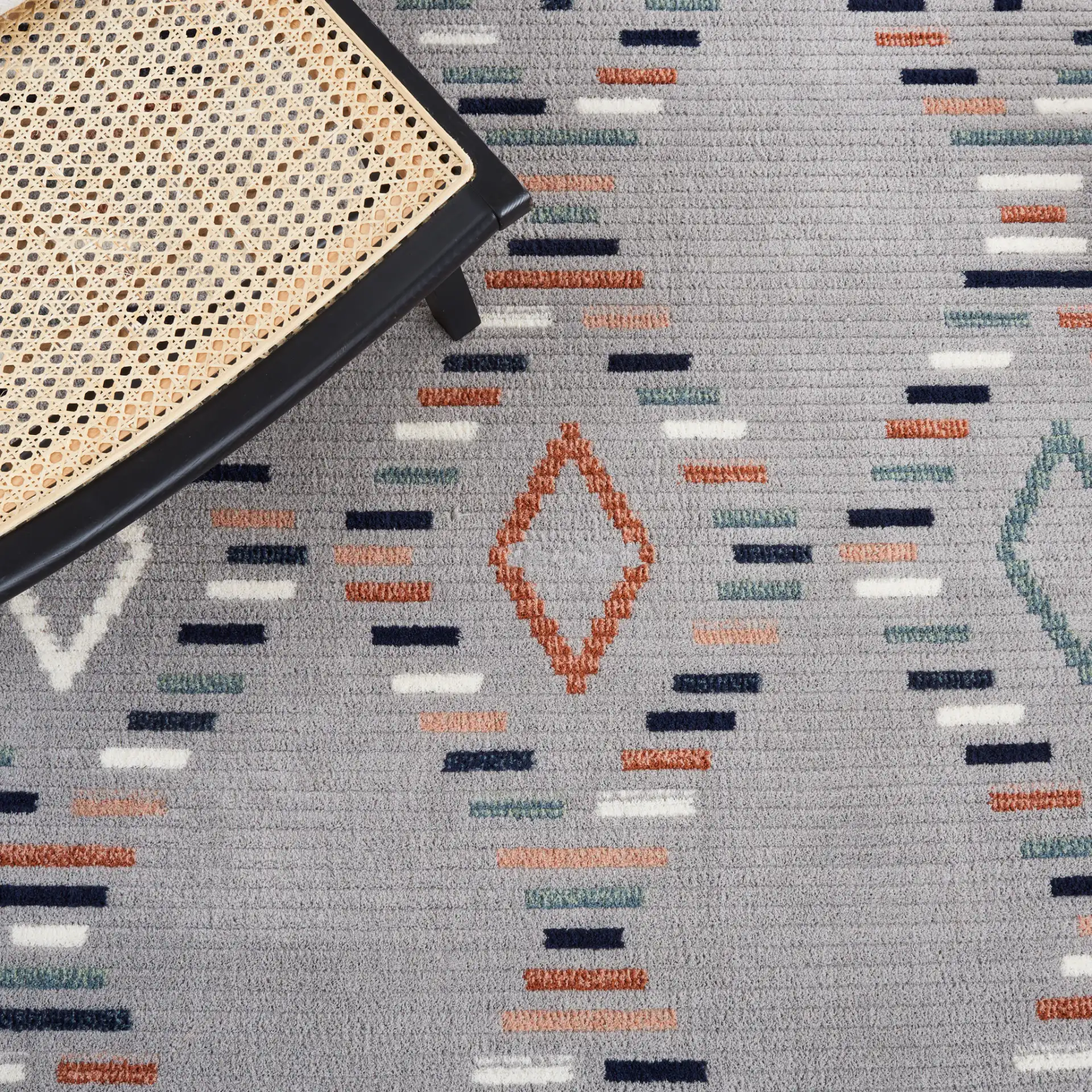 Marrakesh Dashed Diamond Rug in Gray / Blue Rust in a styled room