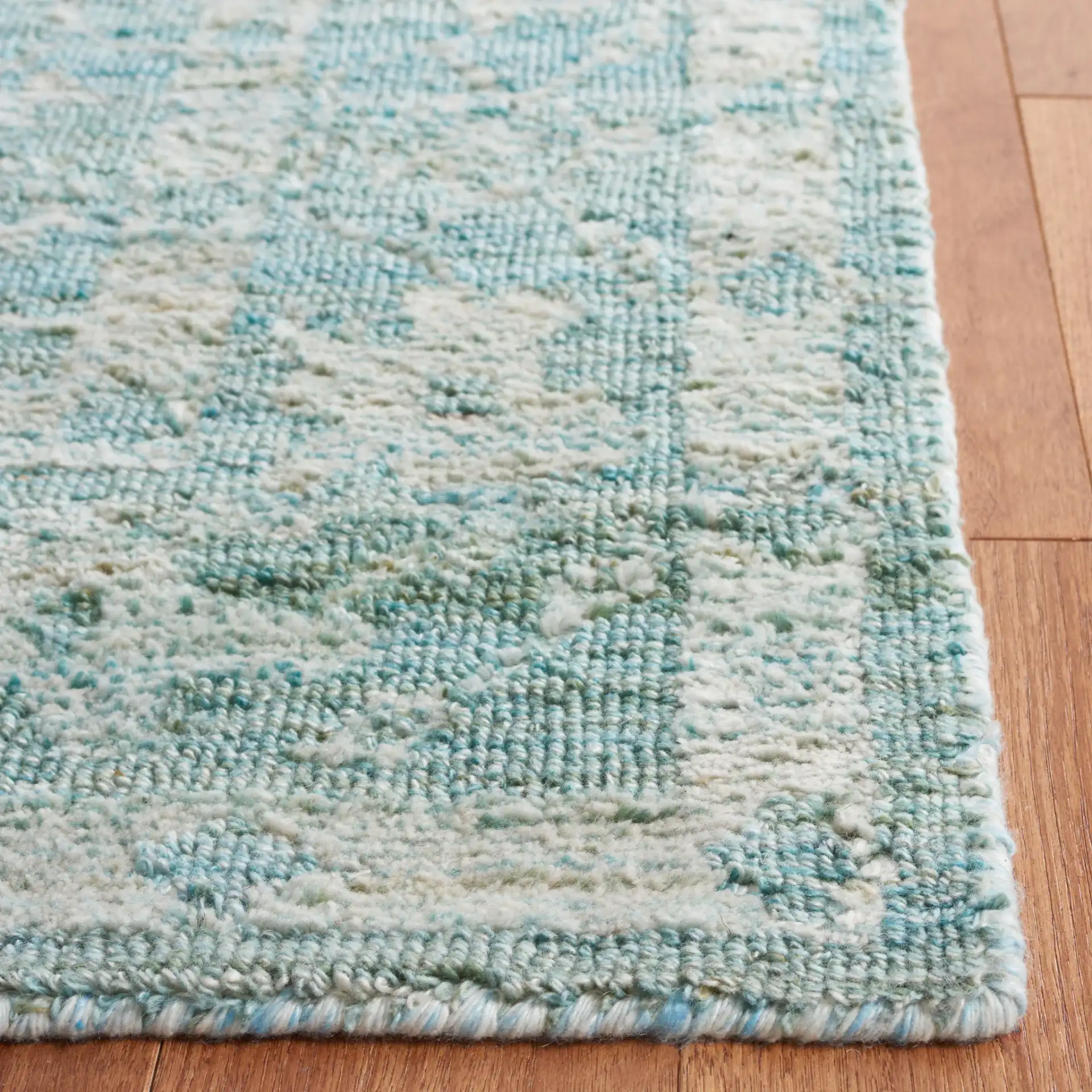 Marquee Floral Medallion Hand-Tufted Rug in Turquoise / Gray in a styled room