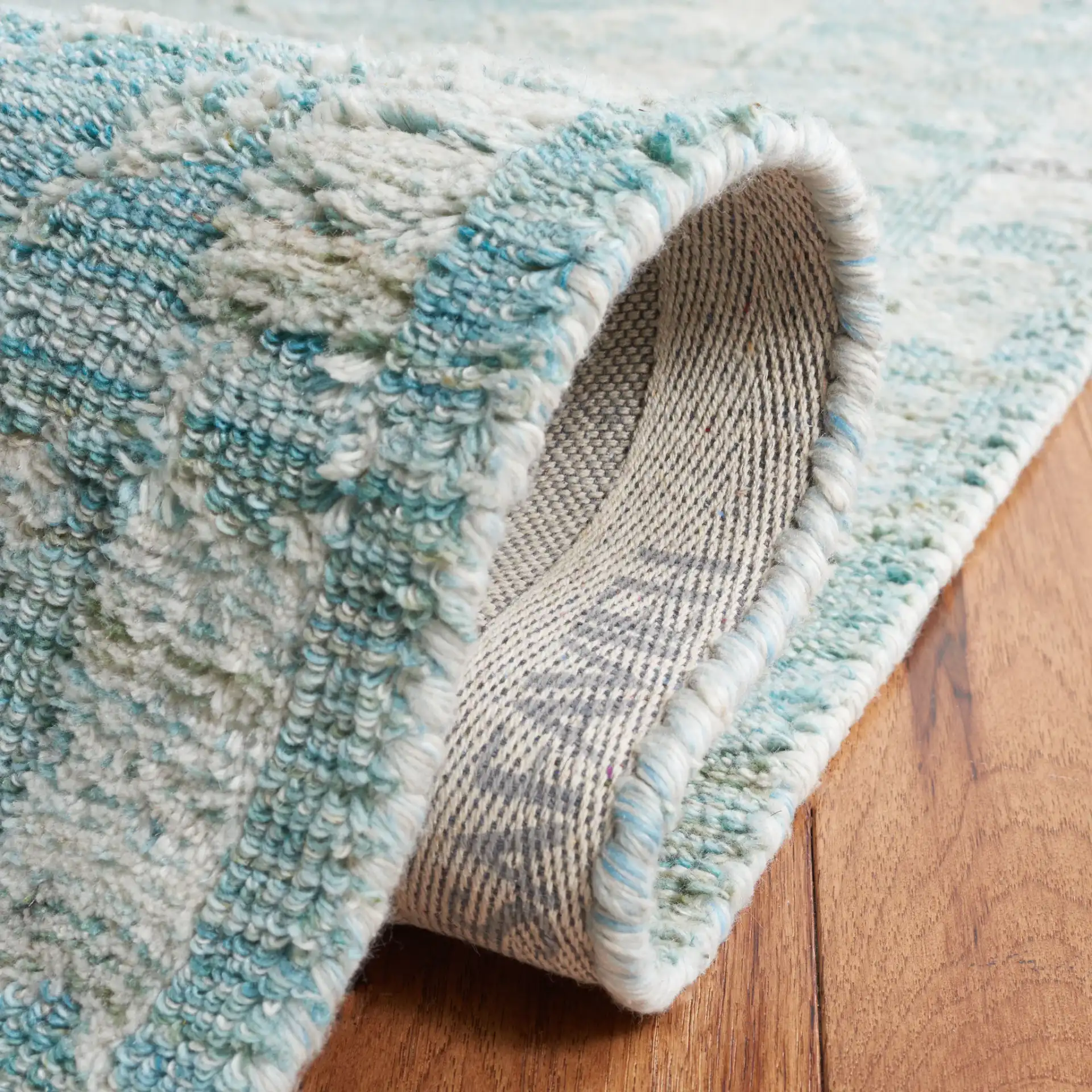 Marquee Floral Medallion Hand-Tufted Rug in Turquoise / Gray in a styled room