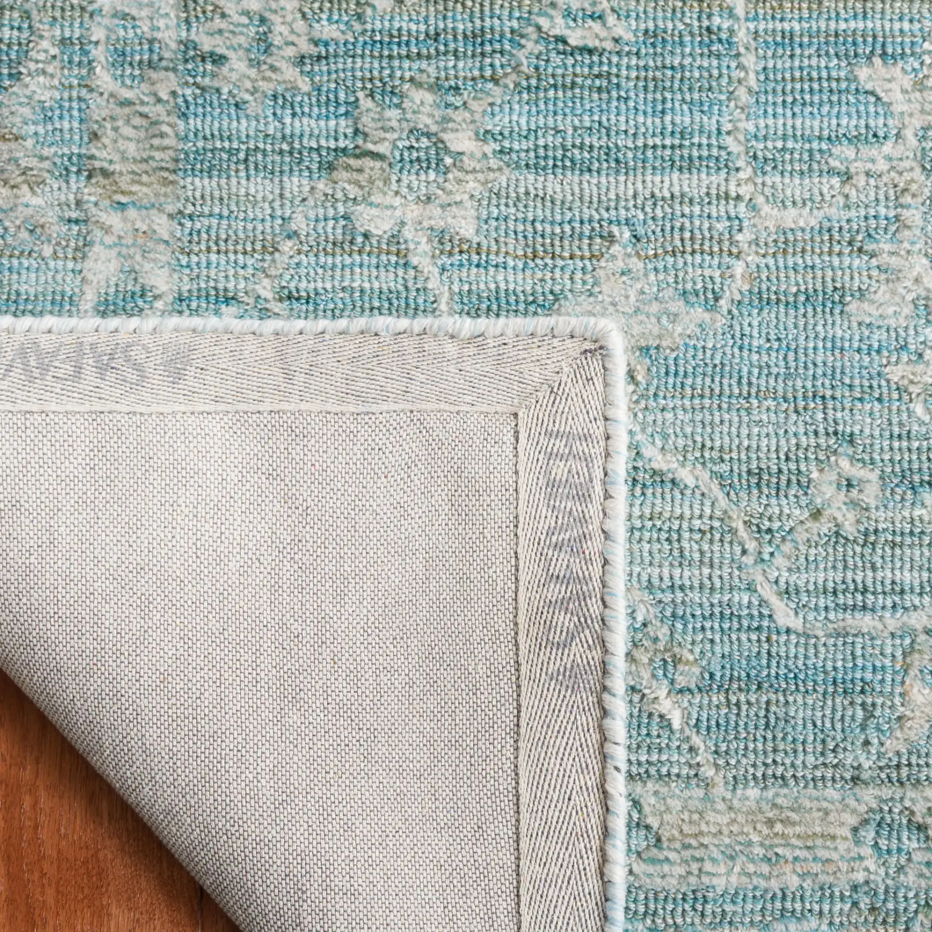 Marquee Floral Medallion Hand-Tufted Rug in Turquoise / Gray in a styled room