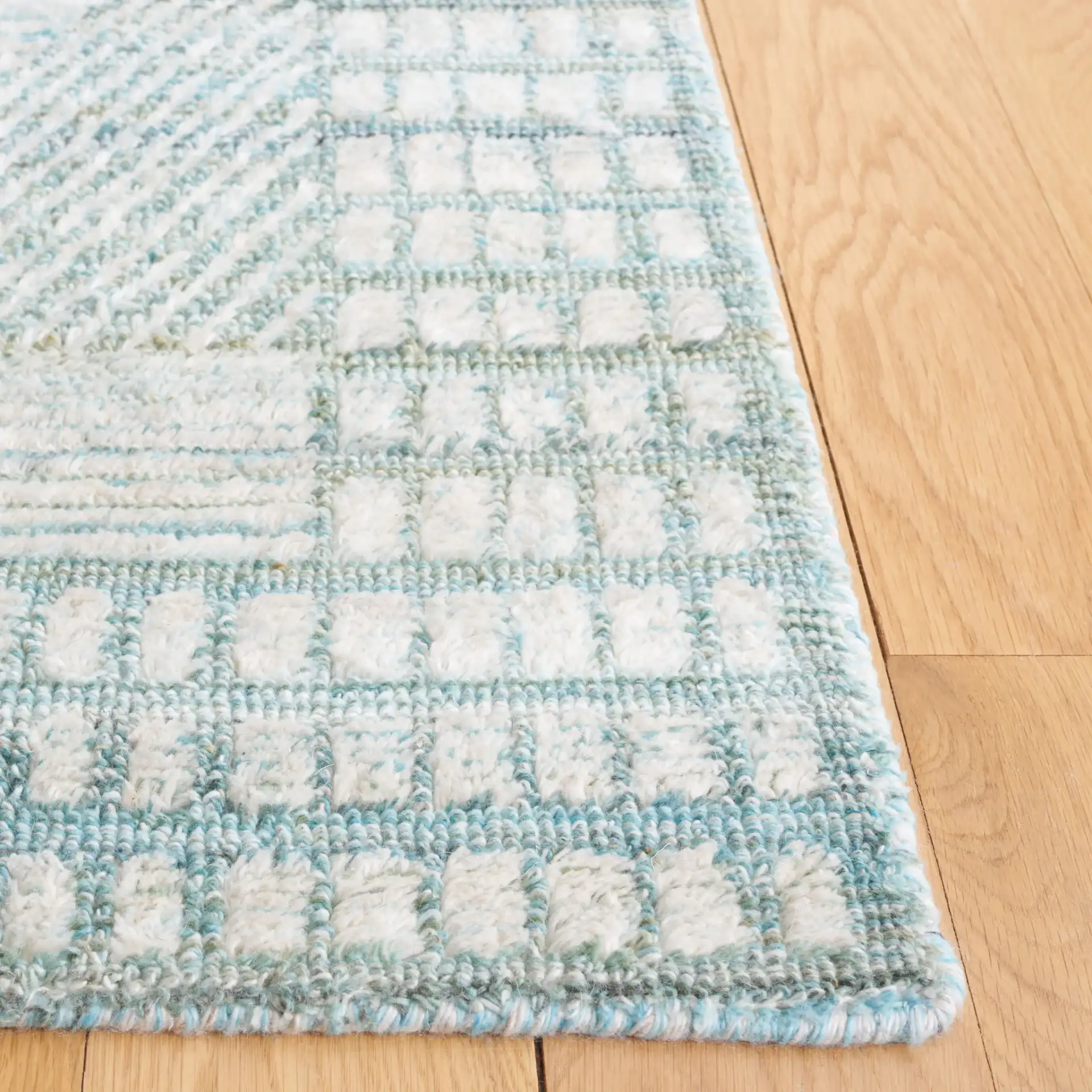 Marquee Interlocking Line Hand-Tufted Rug in Turquoise / Gray in a styled room