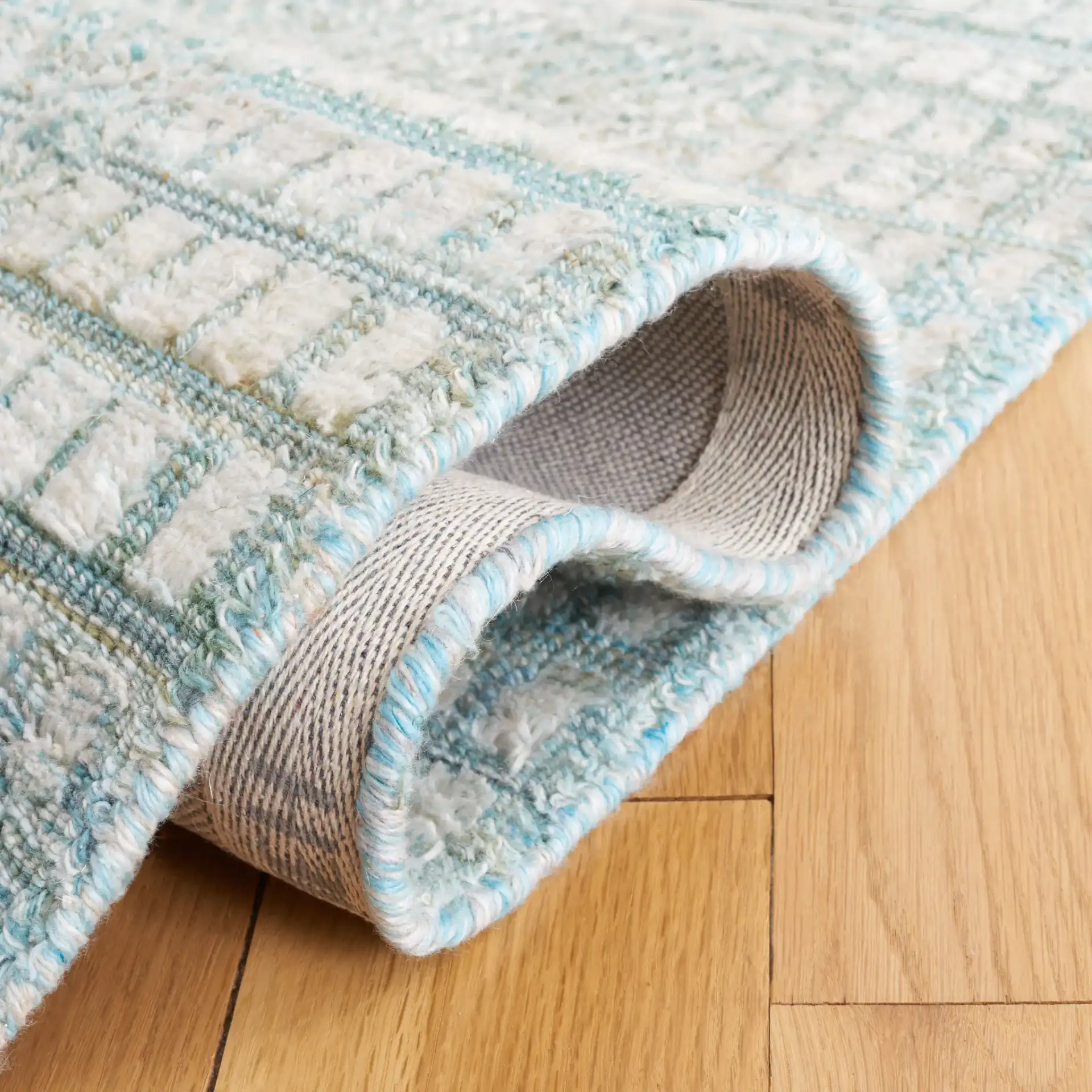 Marquee Interlocking Line Hand-Tufted Rug in Turquoise / Gray in a styled room