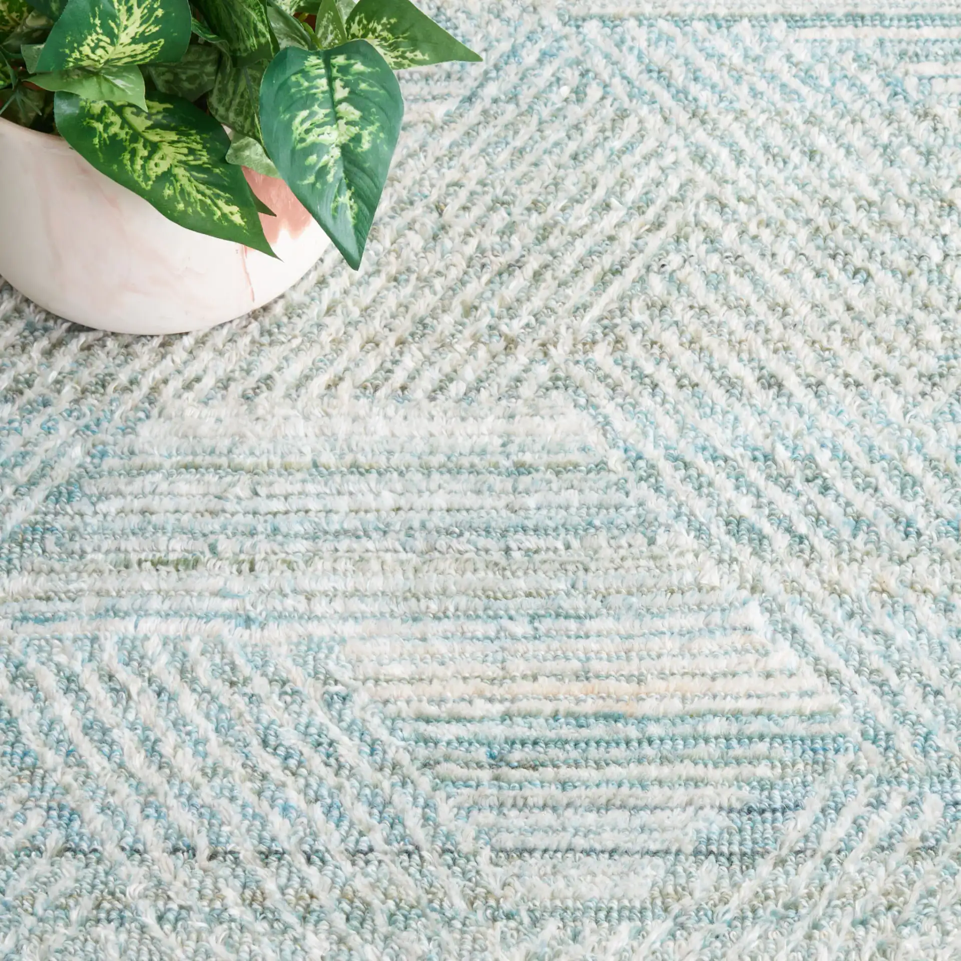 Marquee Interlocking Line Hand-Tufted Rug in Turquoise / Gray in a styled room