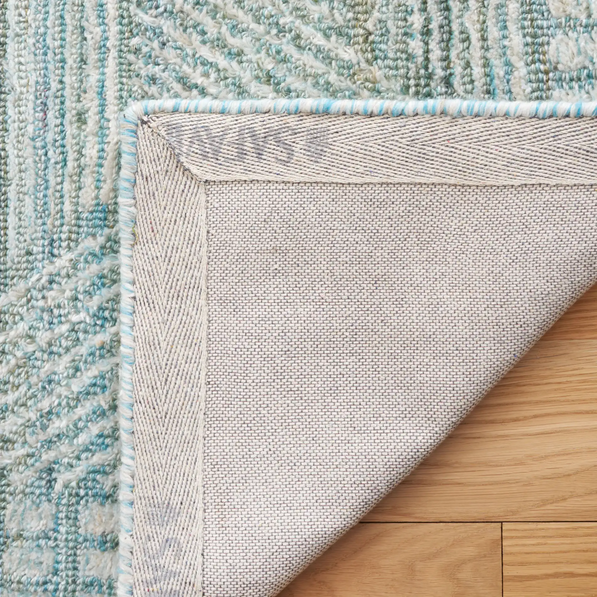Marquee Interlocking Line Hand-Tufted Rug in Turquoise / Gray in a styled room