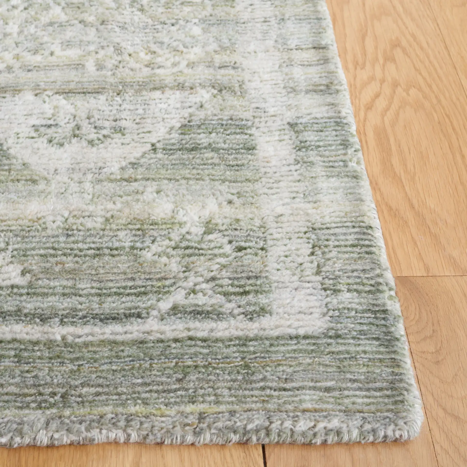Marquee Tribal Medallion Hand-Tufted Rug in Green / Sage in a styled room