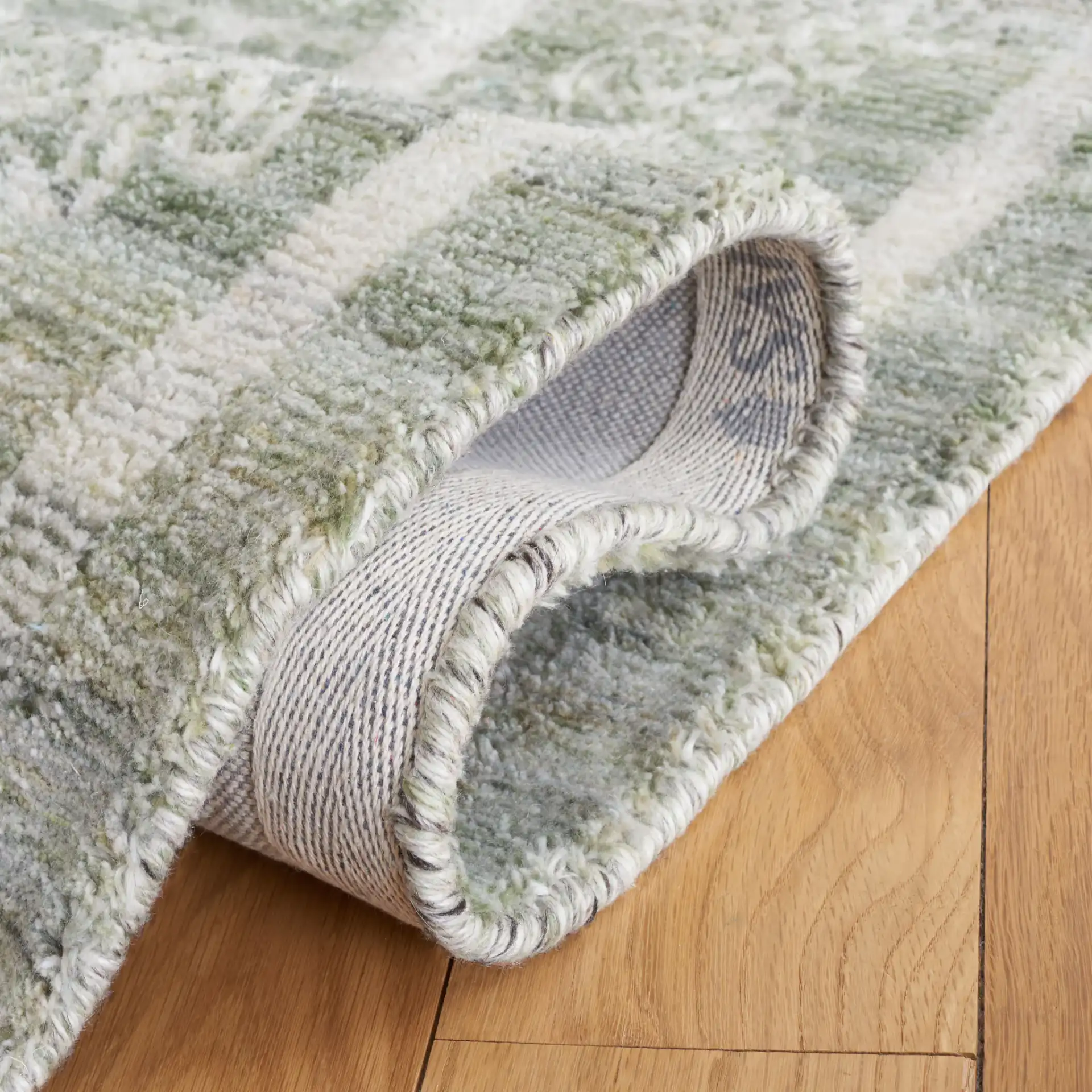 Marquee Tribal Medallion Hand-Tufted Rug in Green / Sage in a styled room
