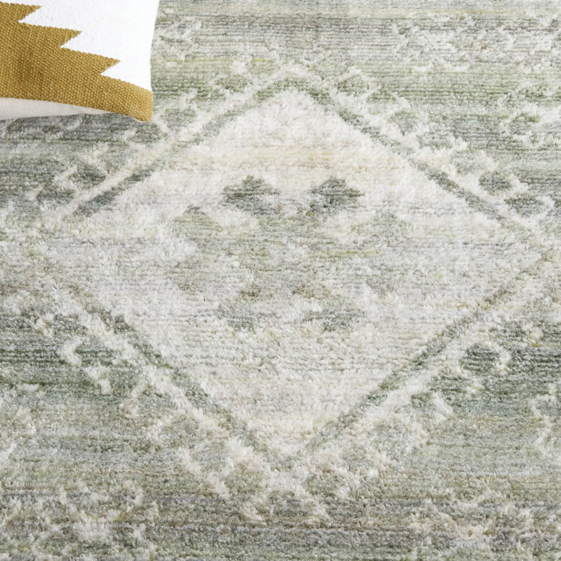 Marquee Tribal Medallion Hand-Tufted Rug in Green / Sage in a styled room