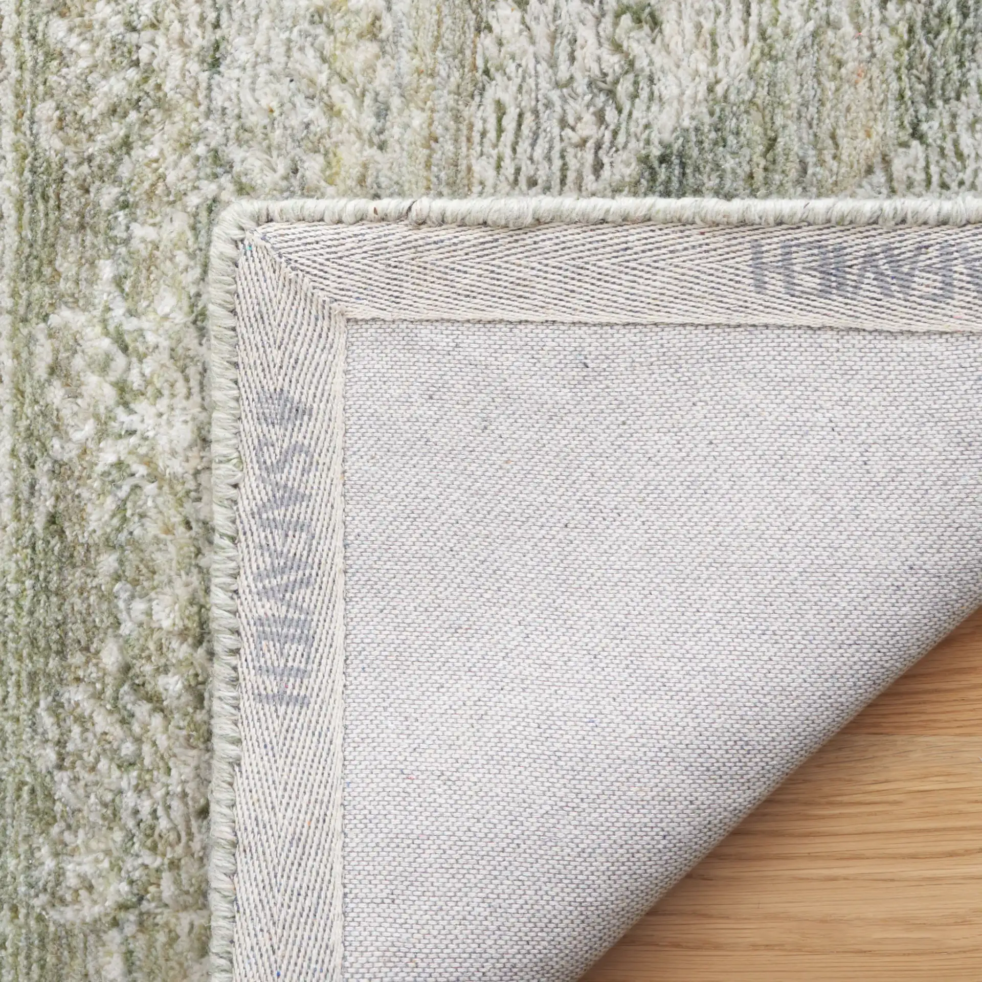Marquee Tribal Medallion Hand-Tufted Rug in Green / Sage in a styled room