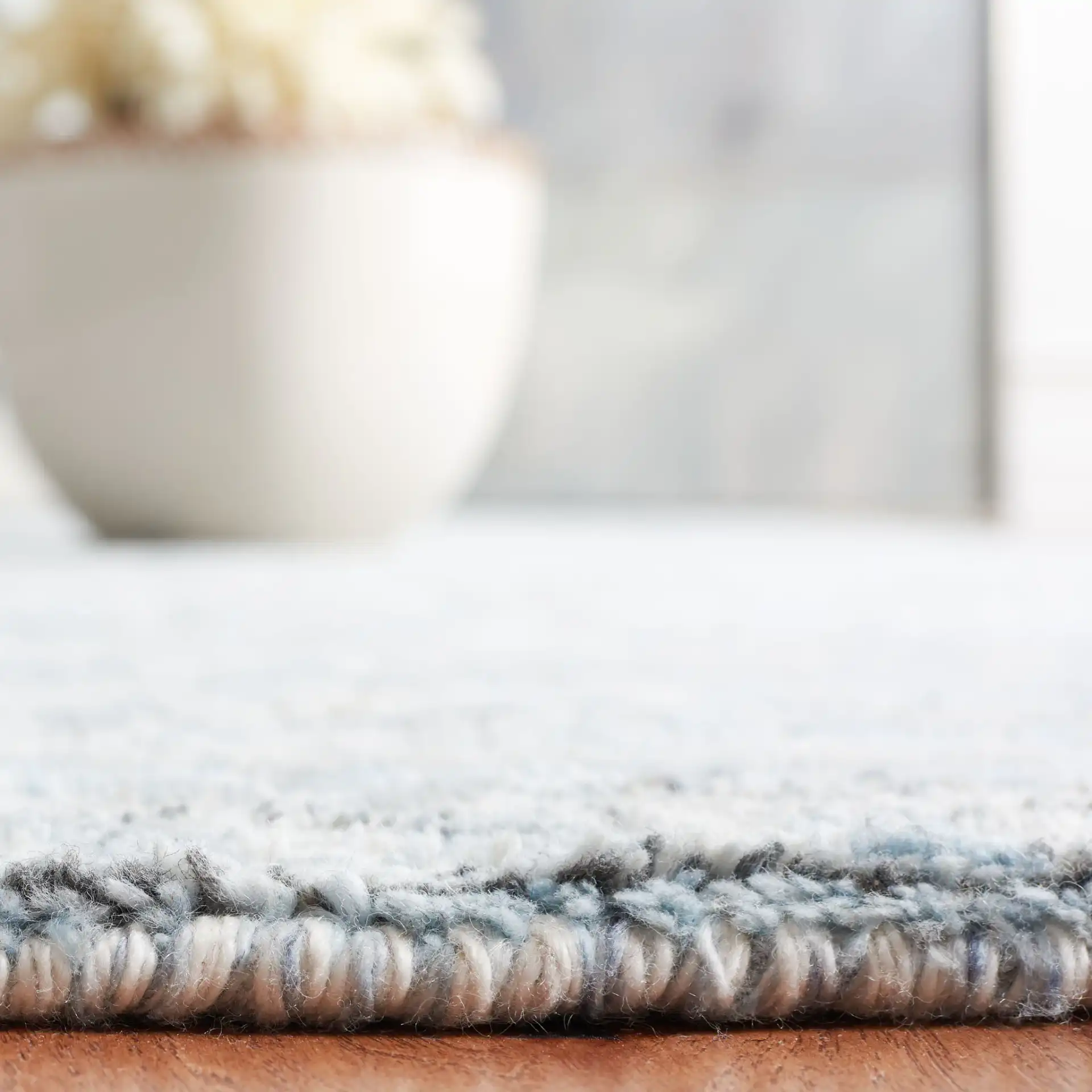Marquee Faded Damask Hand-Tufted Rug in Blue / Gray in a styled room