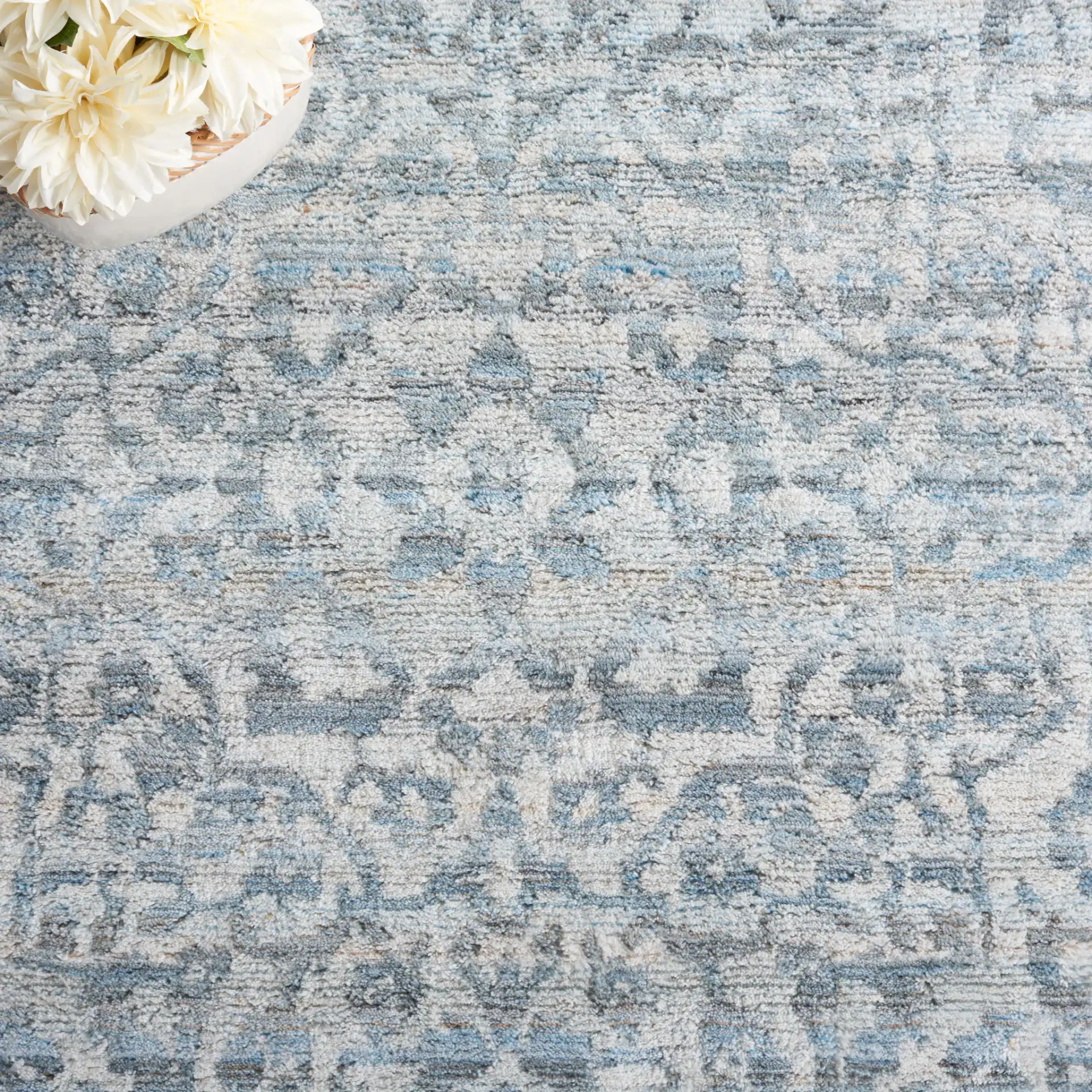 Marquee Faded Damask Hand-Tufted Rug in Blue / Gray in a styled room