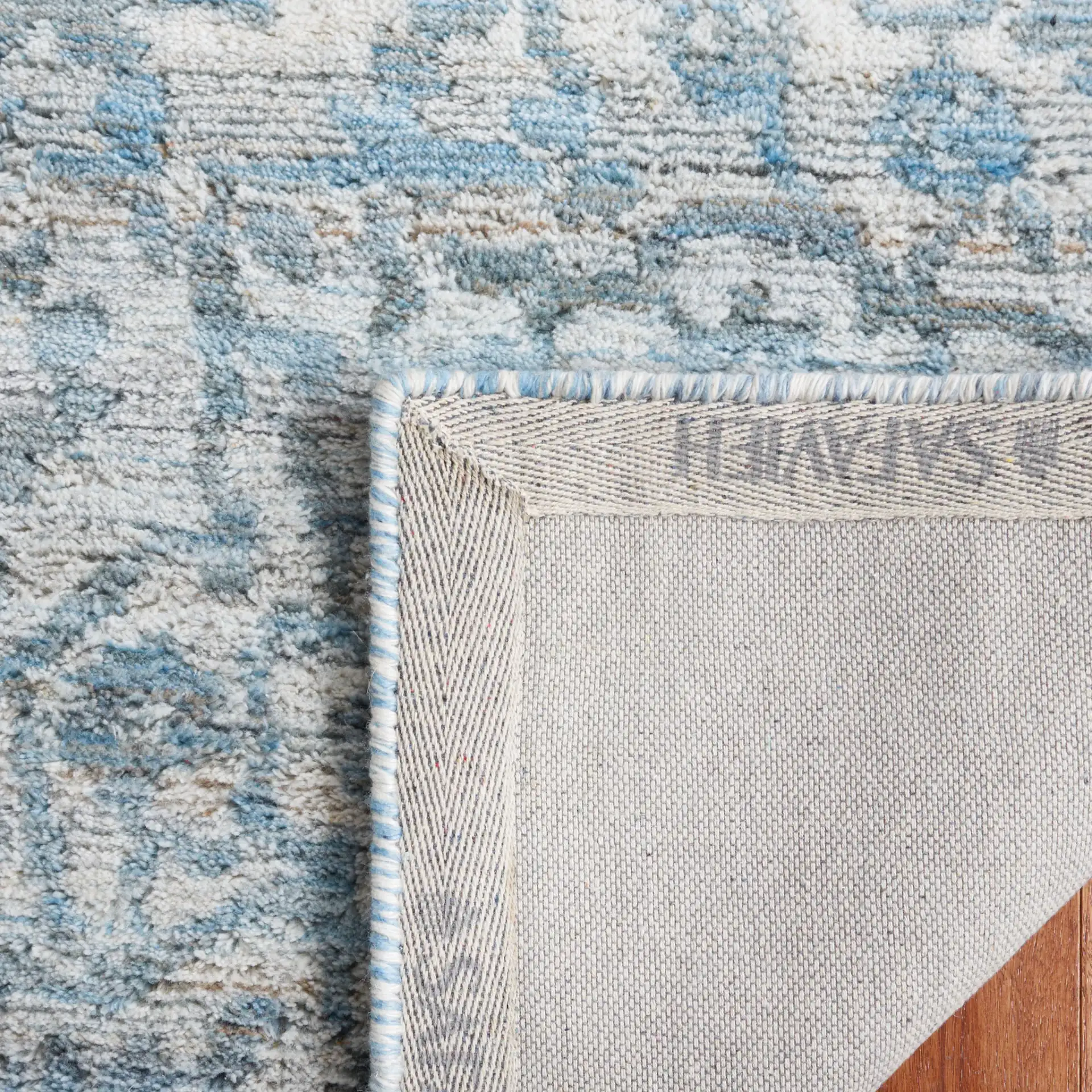 Marquee Faded Damask Hand-Tufted Rug in Blue / Gray in a styled room