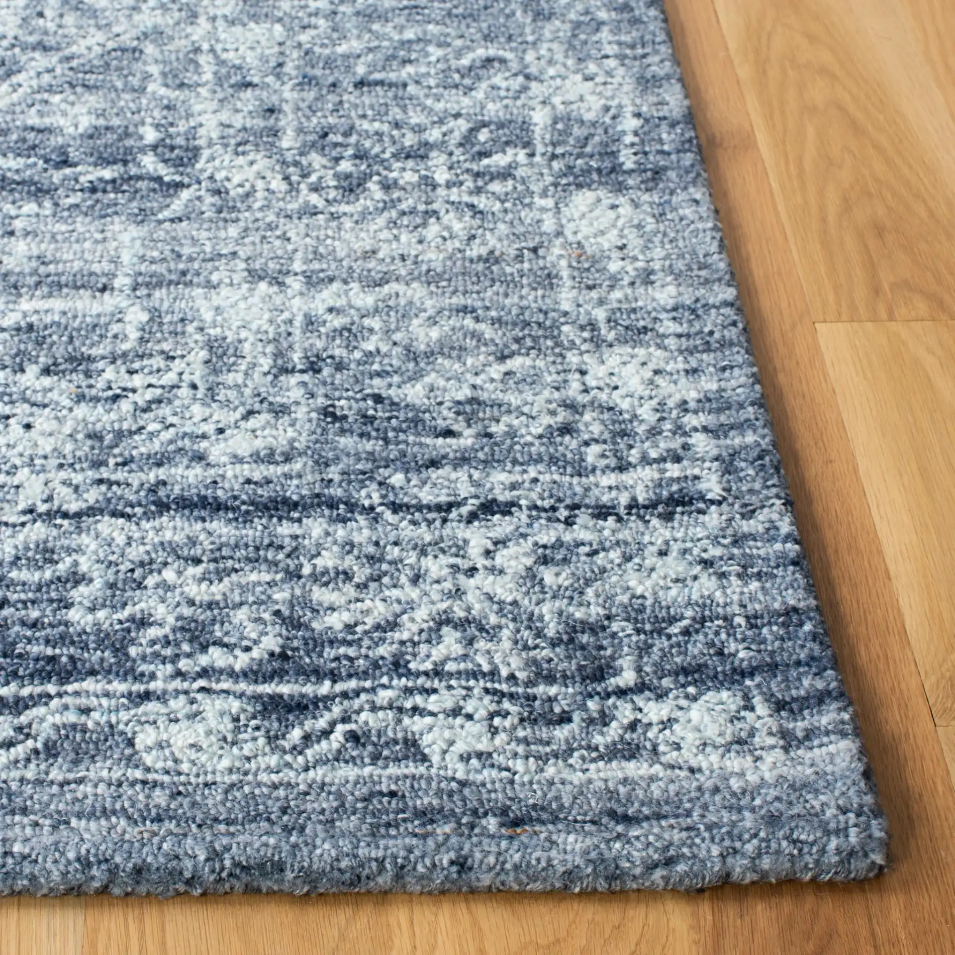 Marquee Framed Medallion Hand-Tufted Rug in Navy in a styled room