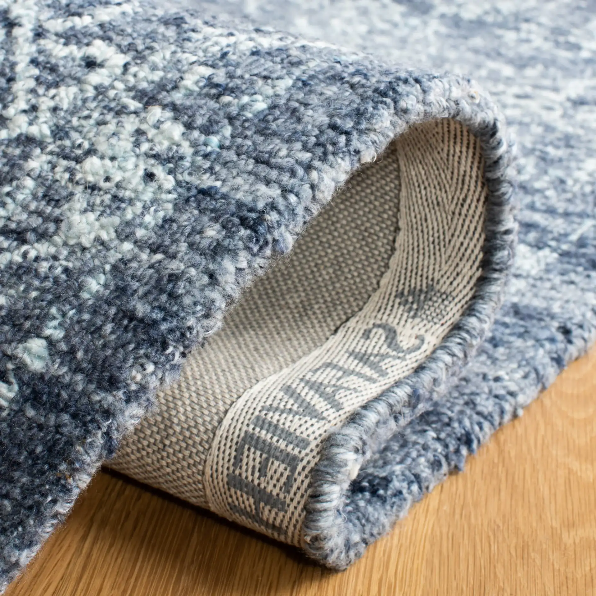 Marquee Framed Medallion Hand-Tufted Rug in Navy in a styled room