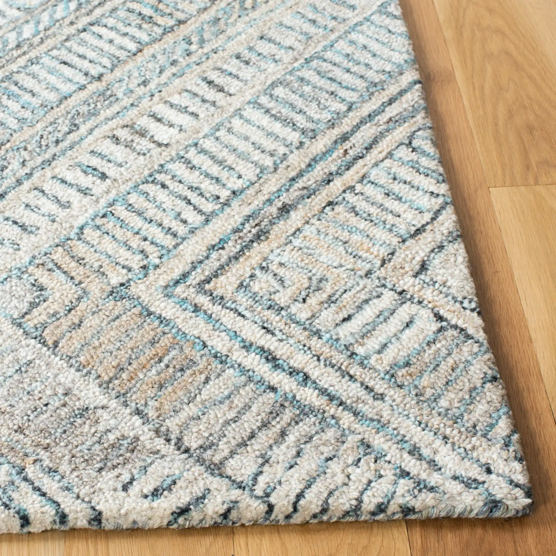 Marquee Concentric Diamond Hand-Tufted Rug in Turquoise / Beige in a styled room