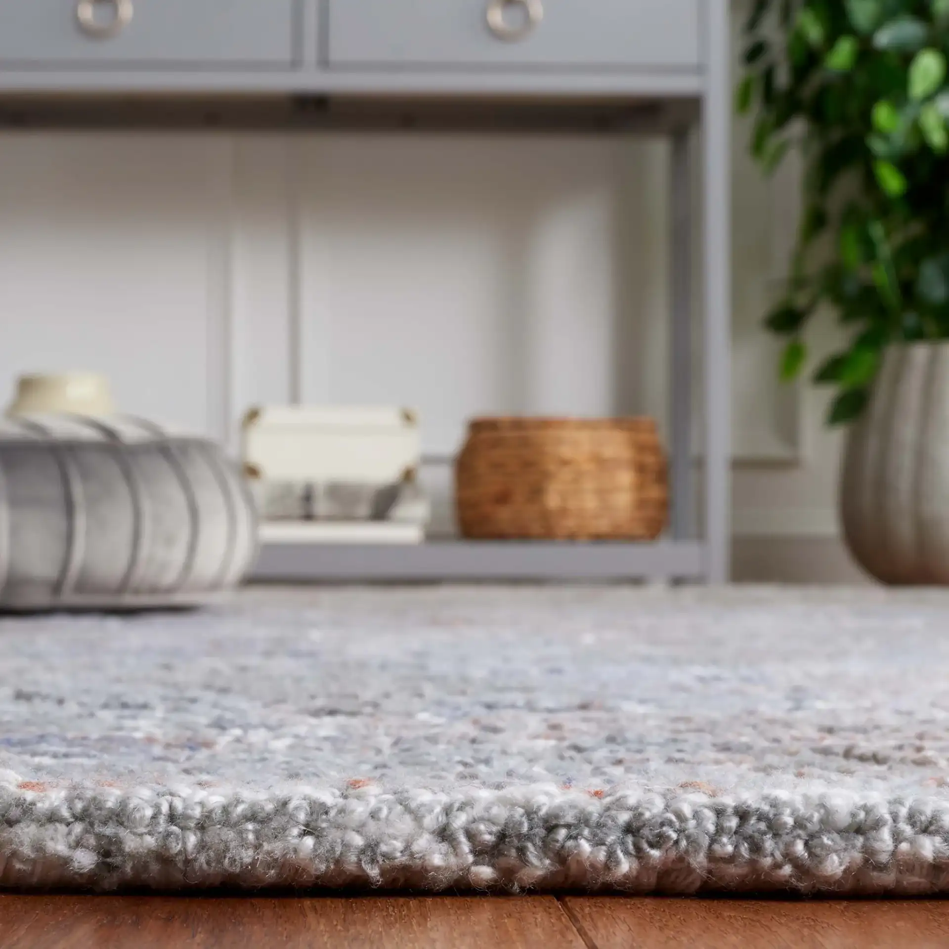Marquee Distressed Floral Hand-Tufted Rug in Rust / Gray in a styled room
