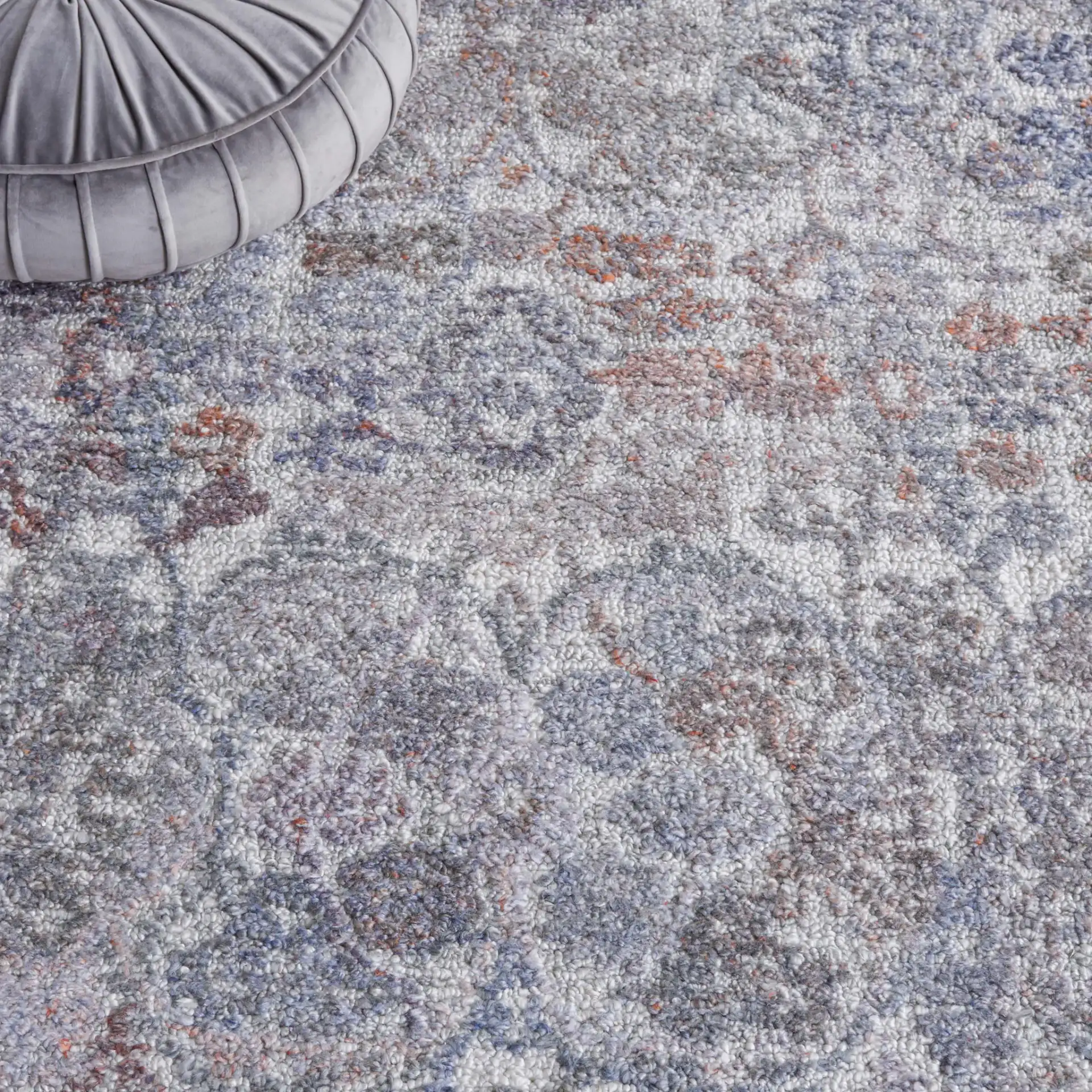 Marquee Distressed Floral Hand-Tufted Rug in Rust / Gray in a styled room