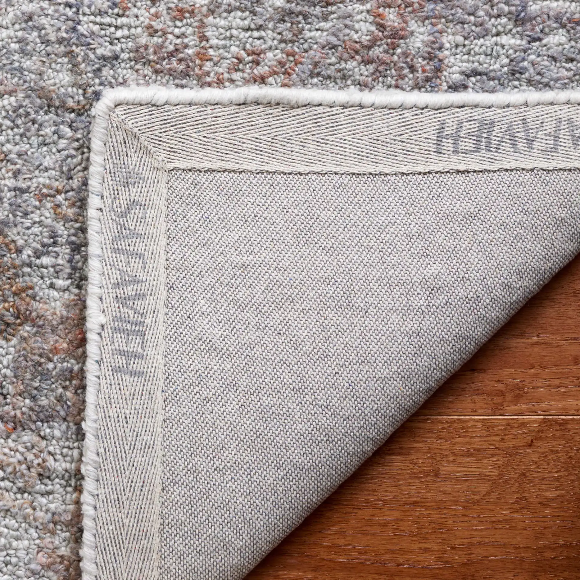 Marquee Distressed Floral Hand-Tufted Rug in Rust / Gray in a styled room