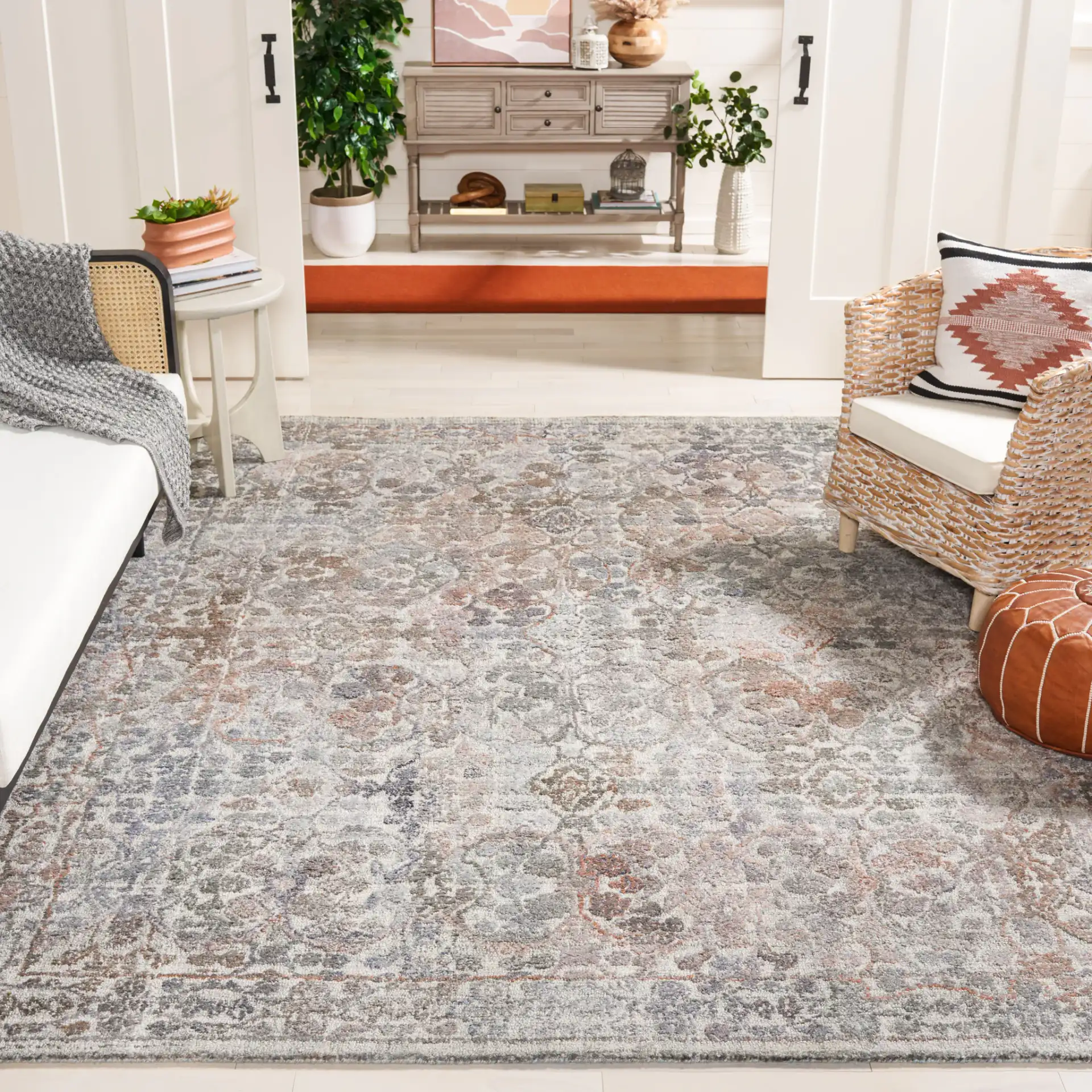 Marquee Distressed Floral Hand-Tufted Rug in Rust / Gray in a styled room