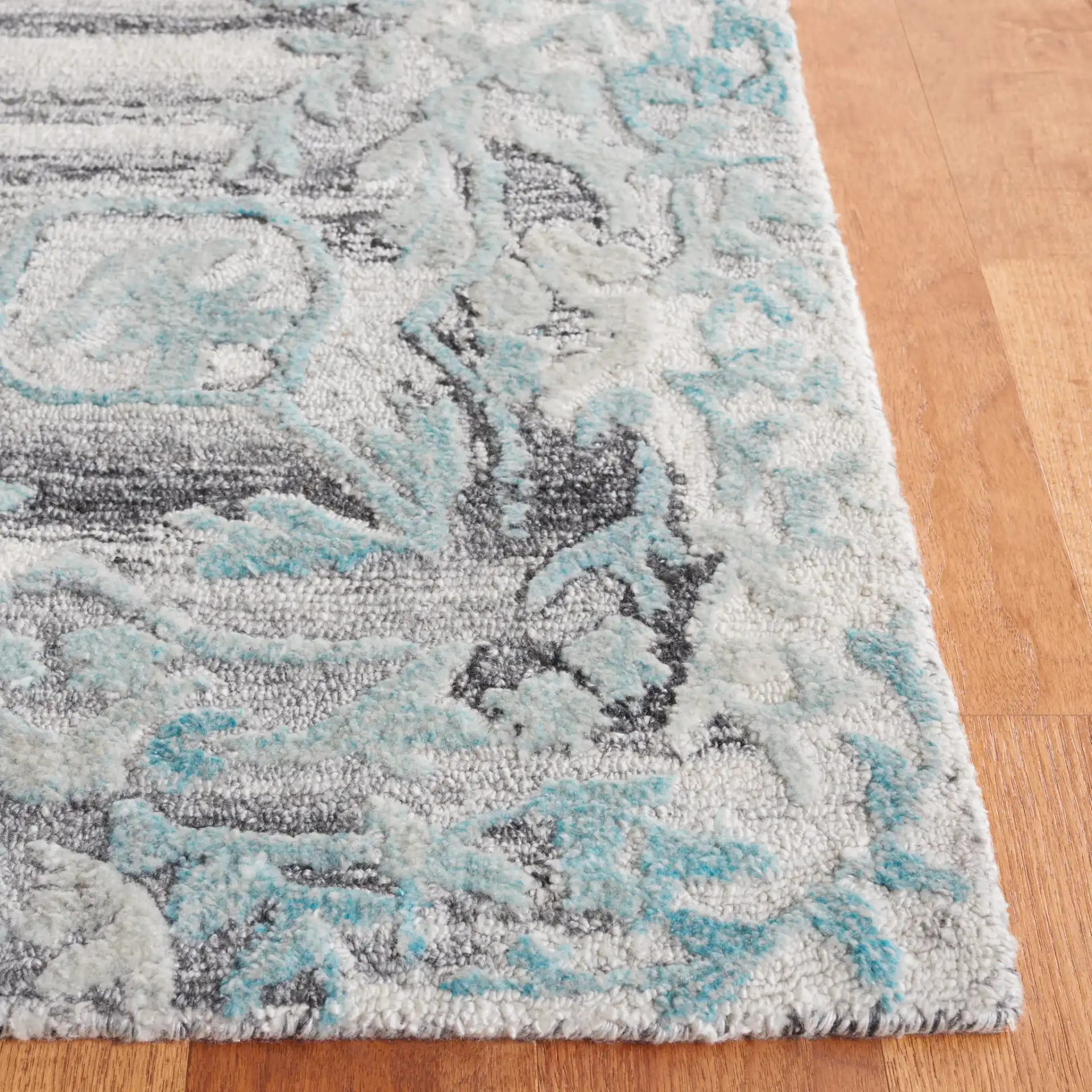 Marquee Striped Medallion Hand-Tufted Rug in Gray / Teal in a styled room