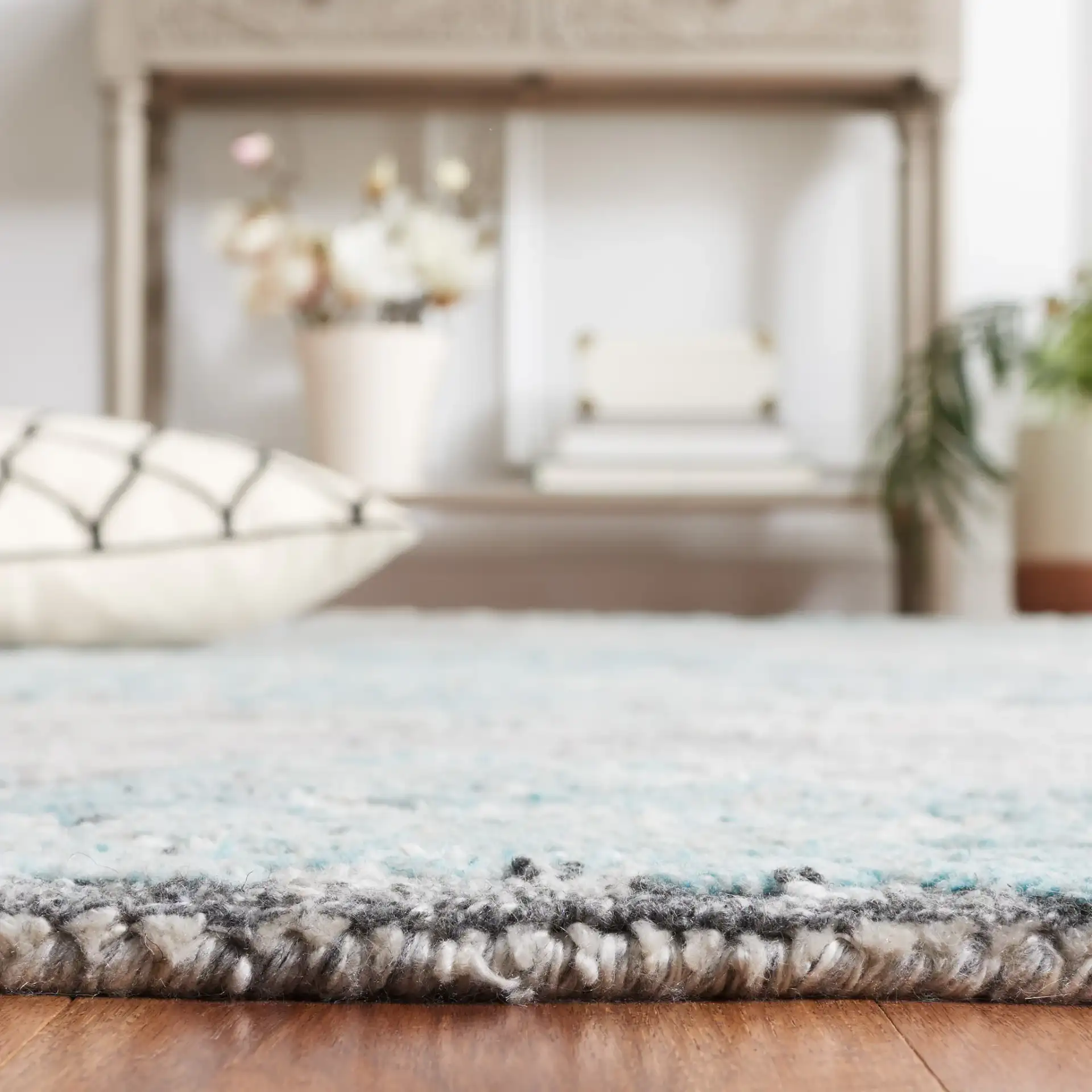 Marquee Striped Medallion Hand-Tufted Rug in Gray / Teal in a styled room