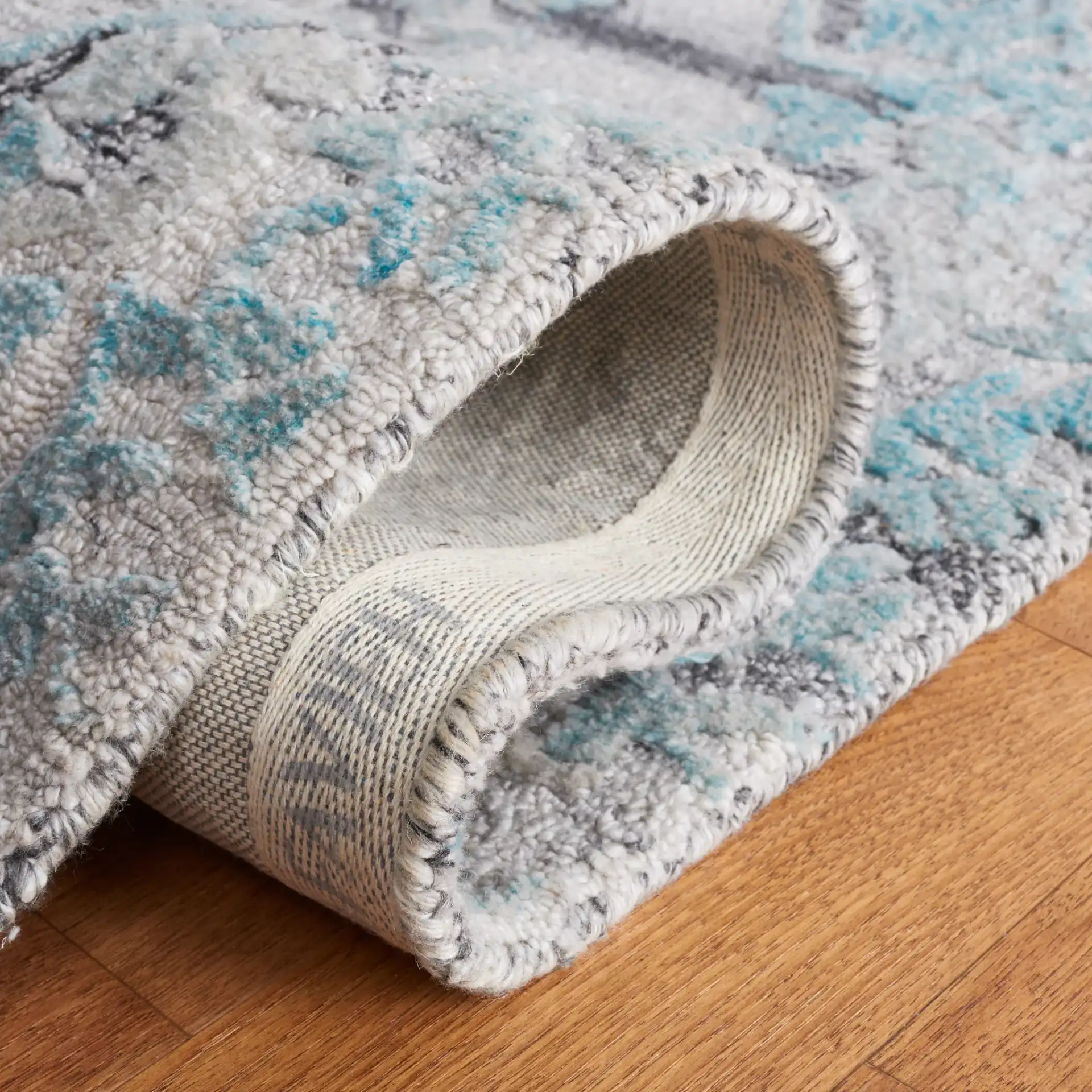 Marquee Striped Medallion Hand-Tufted Rug in Gray / Teal in a styled room