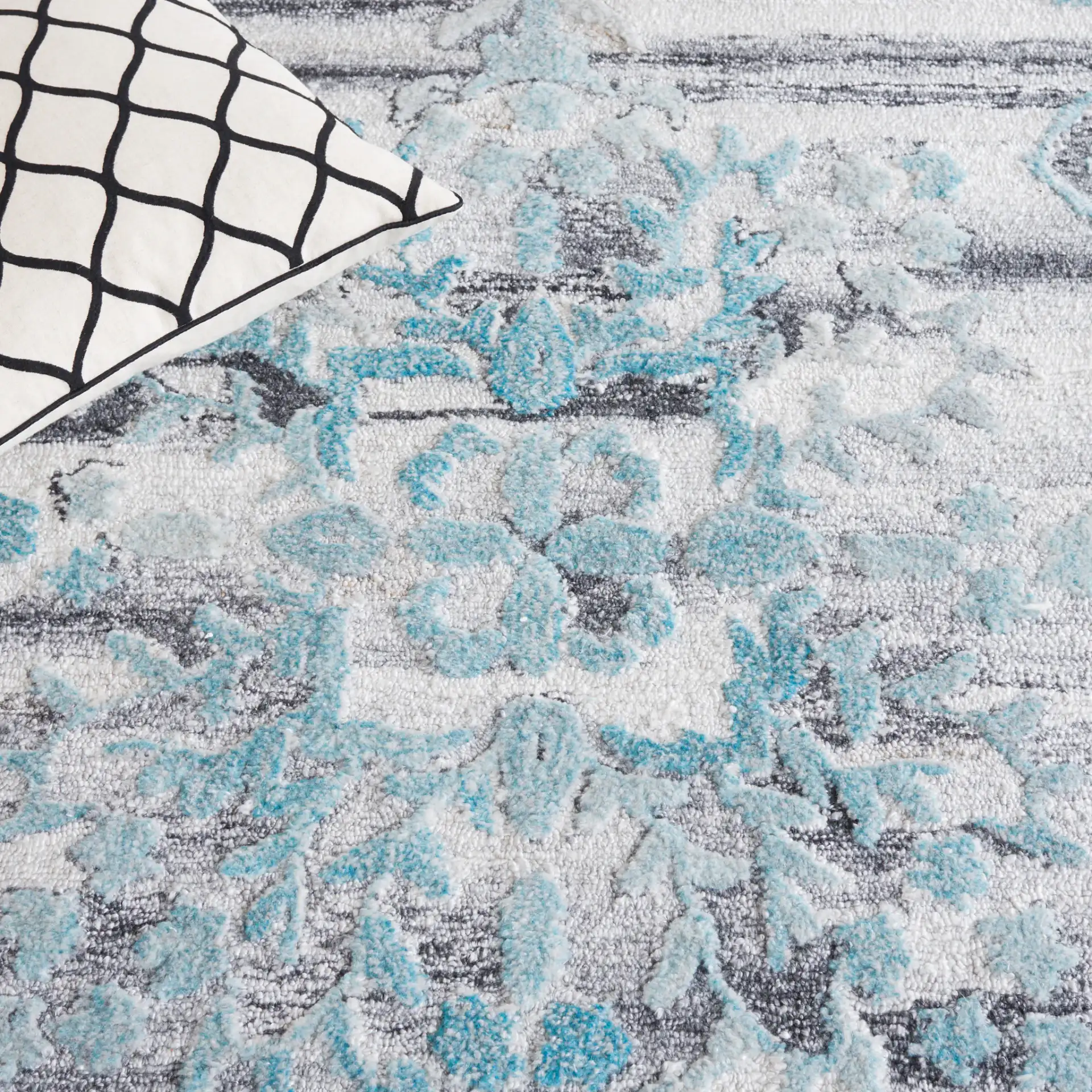 Marquee Striped Medallion Hand-Tufted Rug in Gray / Teal in a styled room