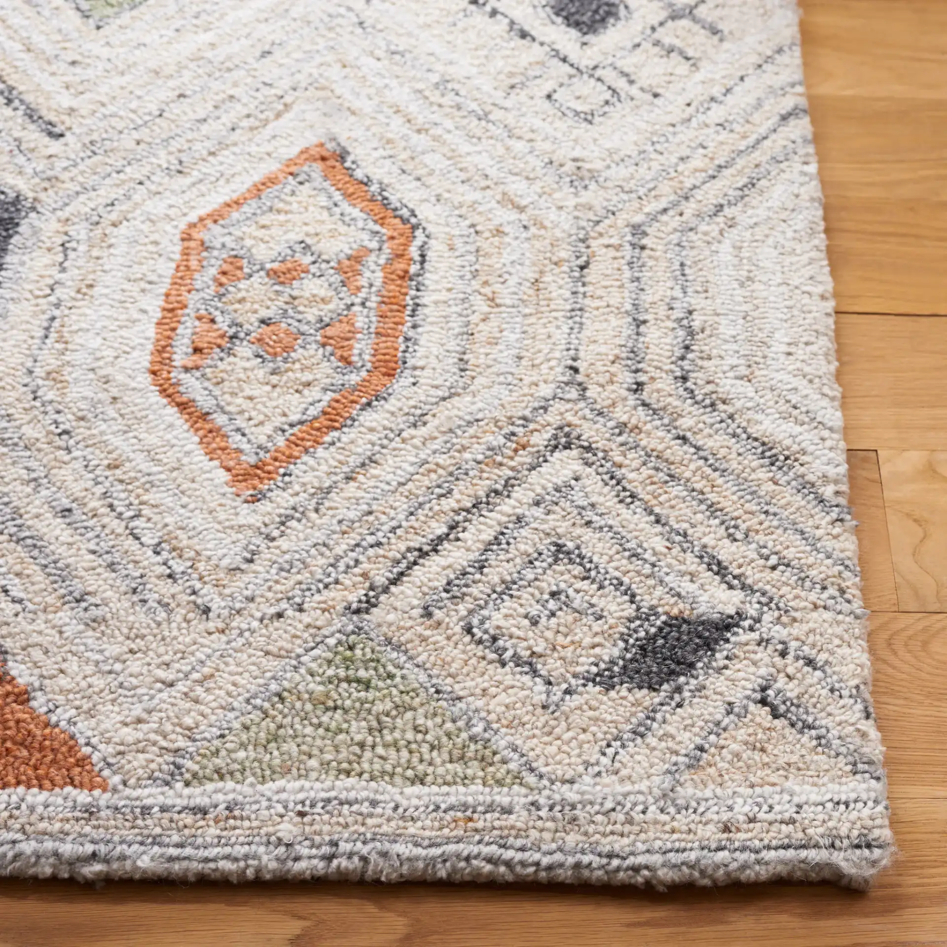 Marquee Tribal Diamond Hand-Tufted Rug in Rust / Gray in a styled room
