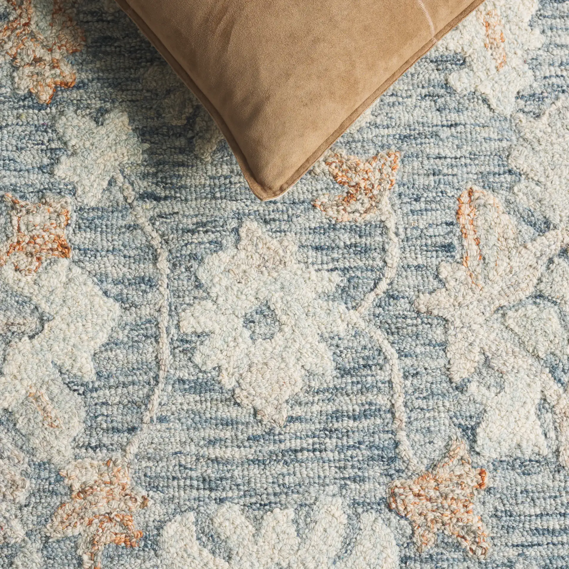 Marquee Oversized Floral Hand-Tufted Wool Rug in Blue / Rust in a styled room