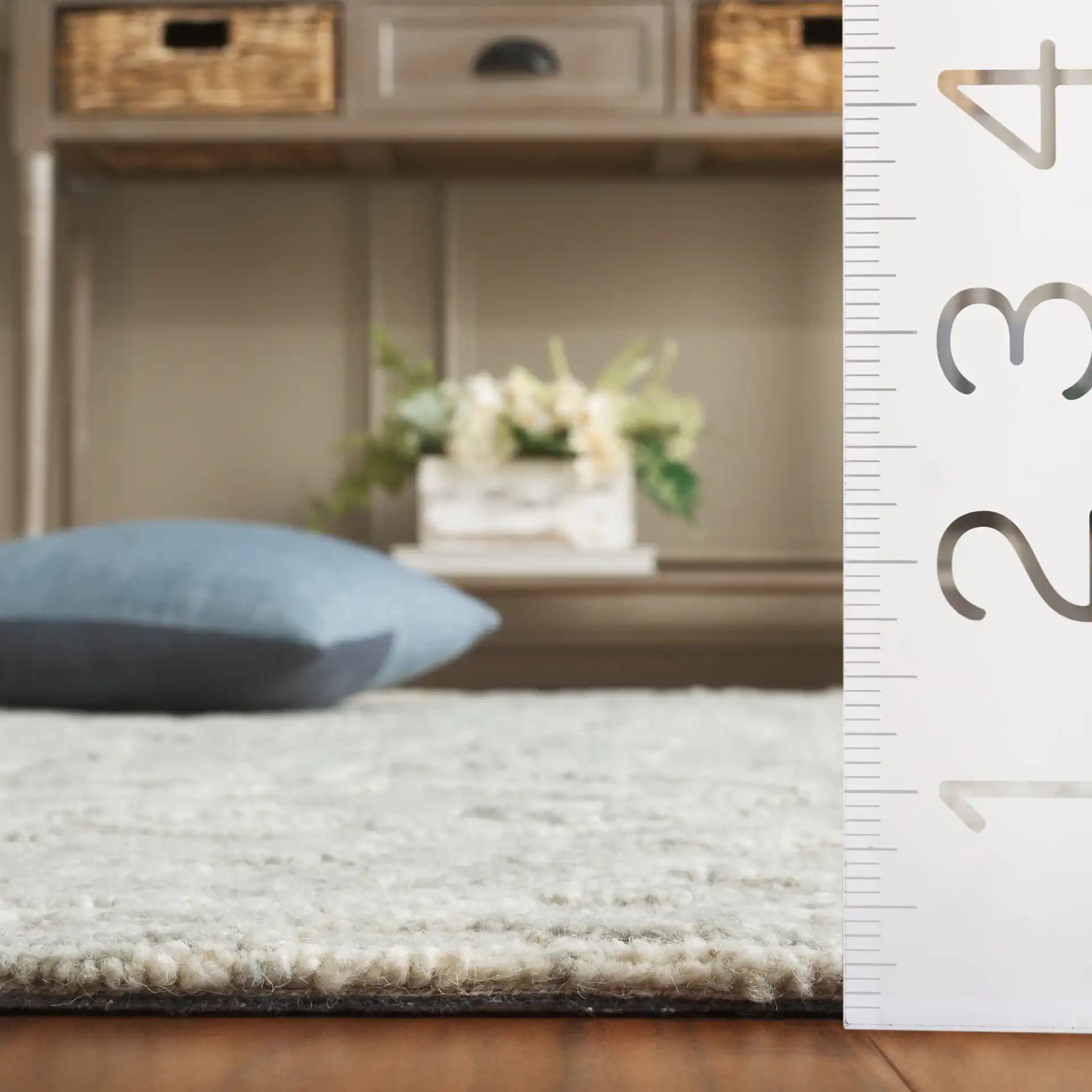 Marquee Floral Vine Bordered Hand-Tufted Rug in Gray / Ivory in a styled room