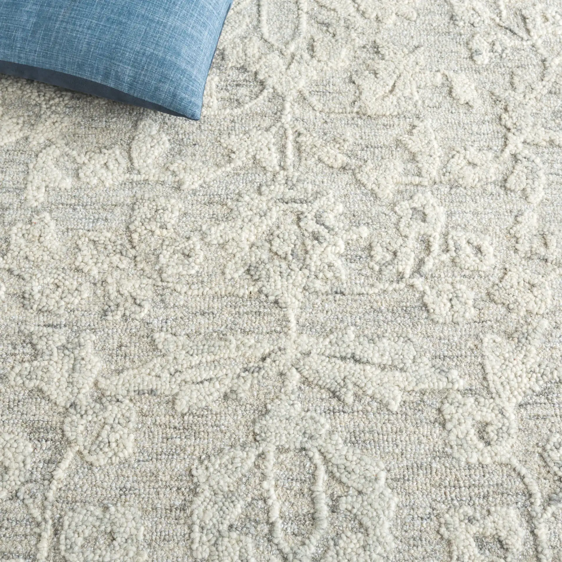 Marquee Floral Vine Bordered Hand-Tufted Rug in Gray / Ivory in a styled room