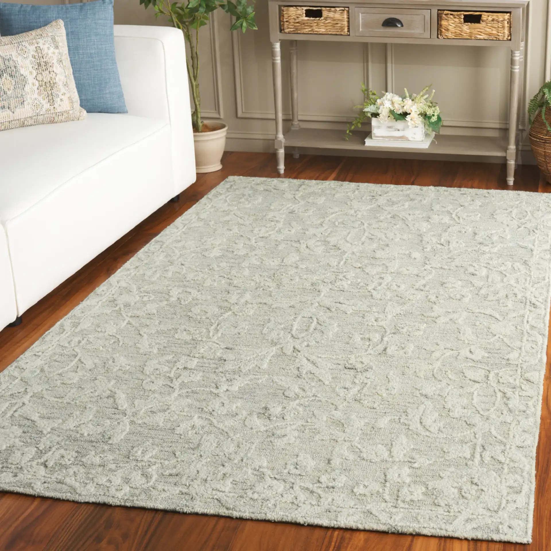 Marquee Floral Vine Bordered Hand-Tufted Rug in Gray / Ivory in a styled room