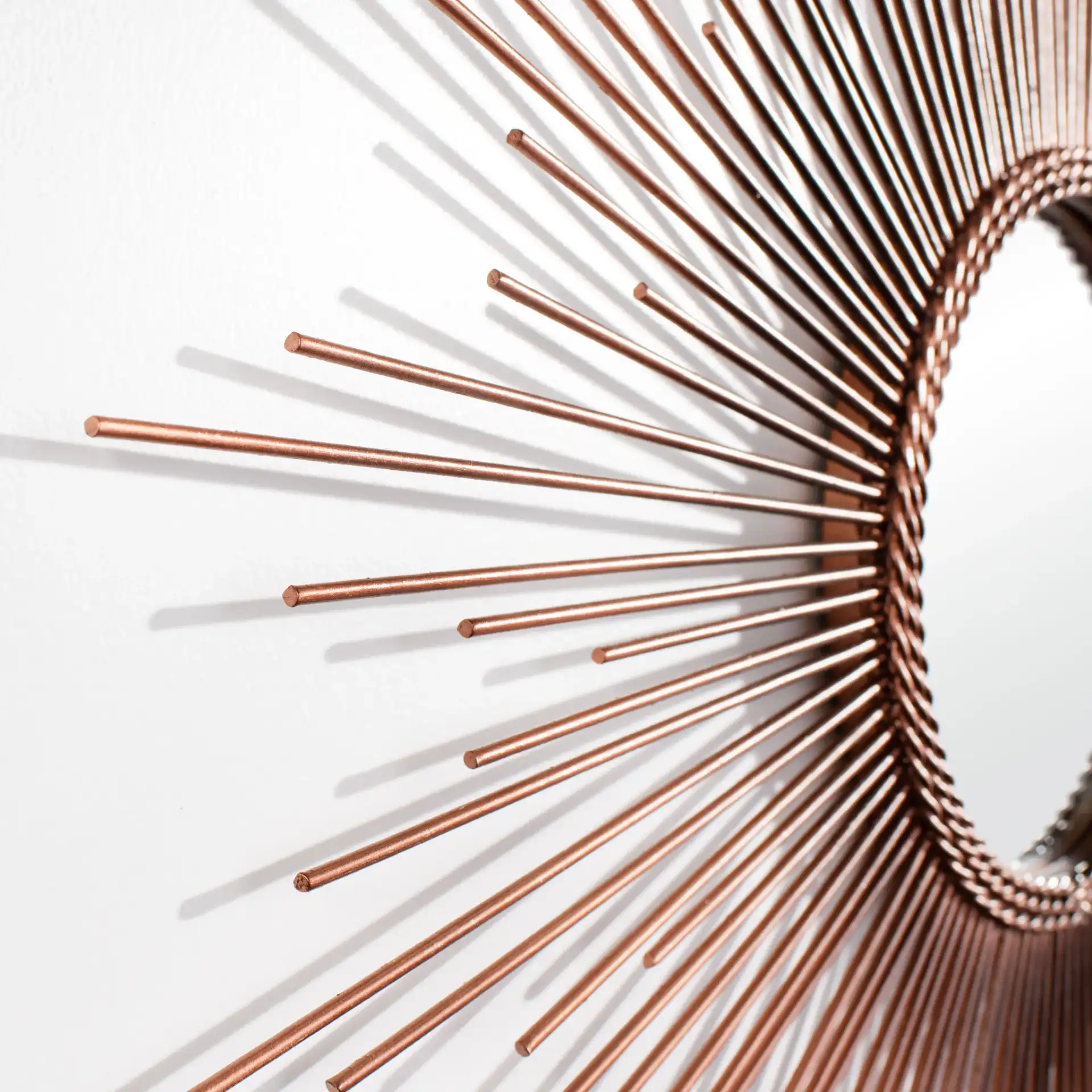 Genevieve Sunburst Mirror in Copper in a styled room