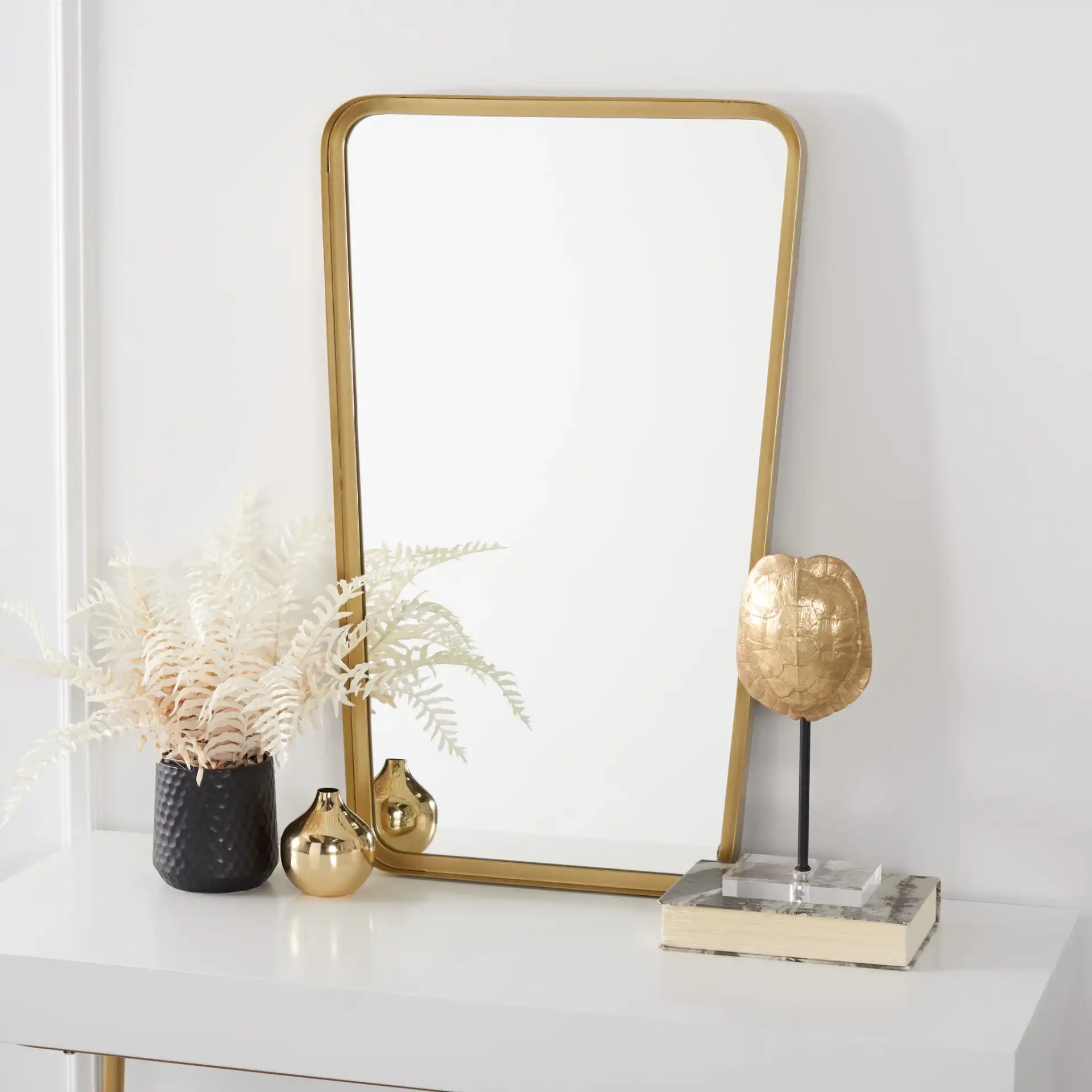 Alta Mirror in Brushed Brass in a styled room