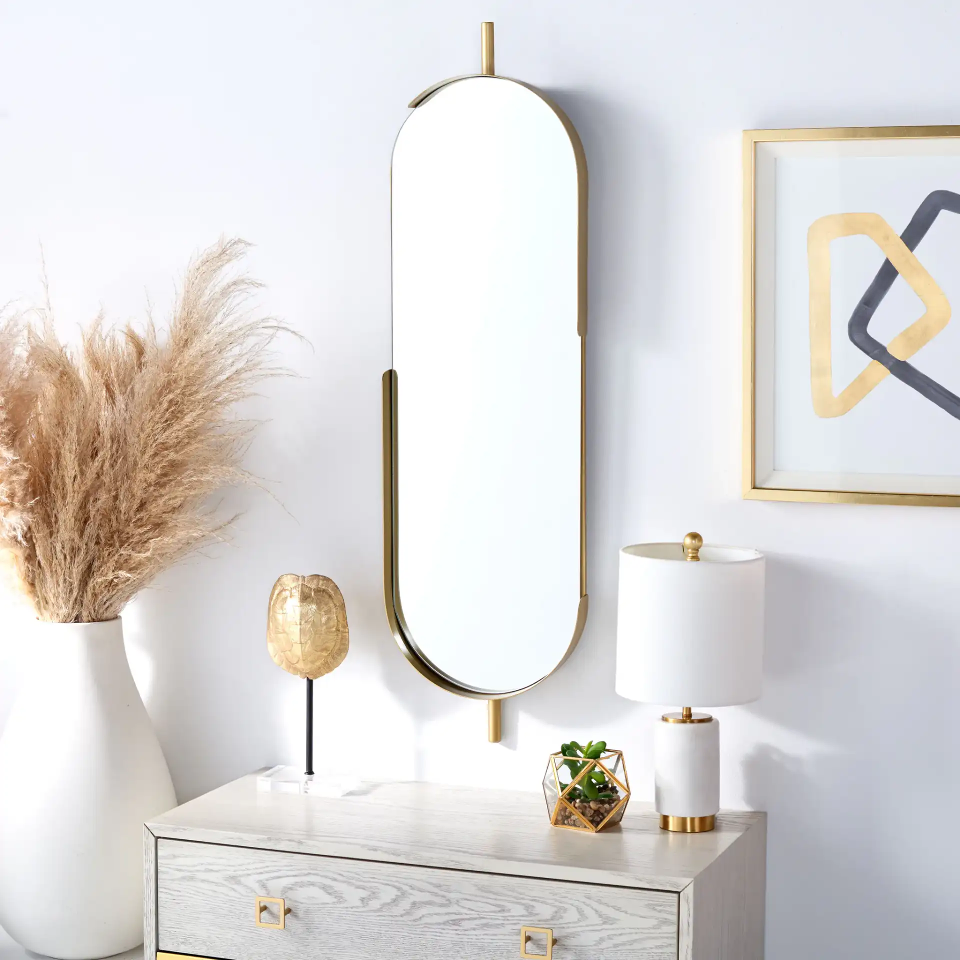 Nicoli 12-Inch Mirror in Brushed Brass in a styled room