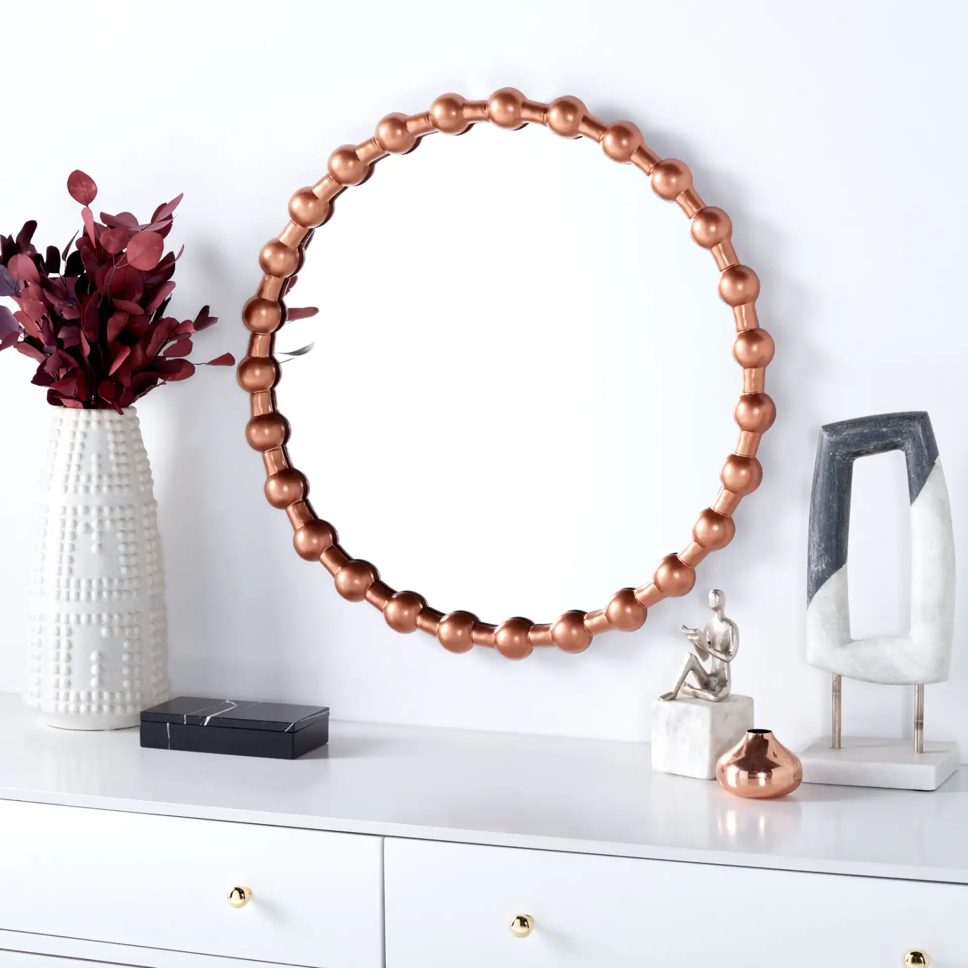 Pallas 25" Mirror in Brushed Copper in a styled room