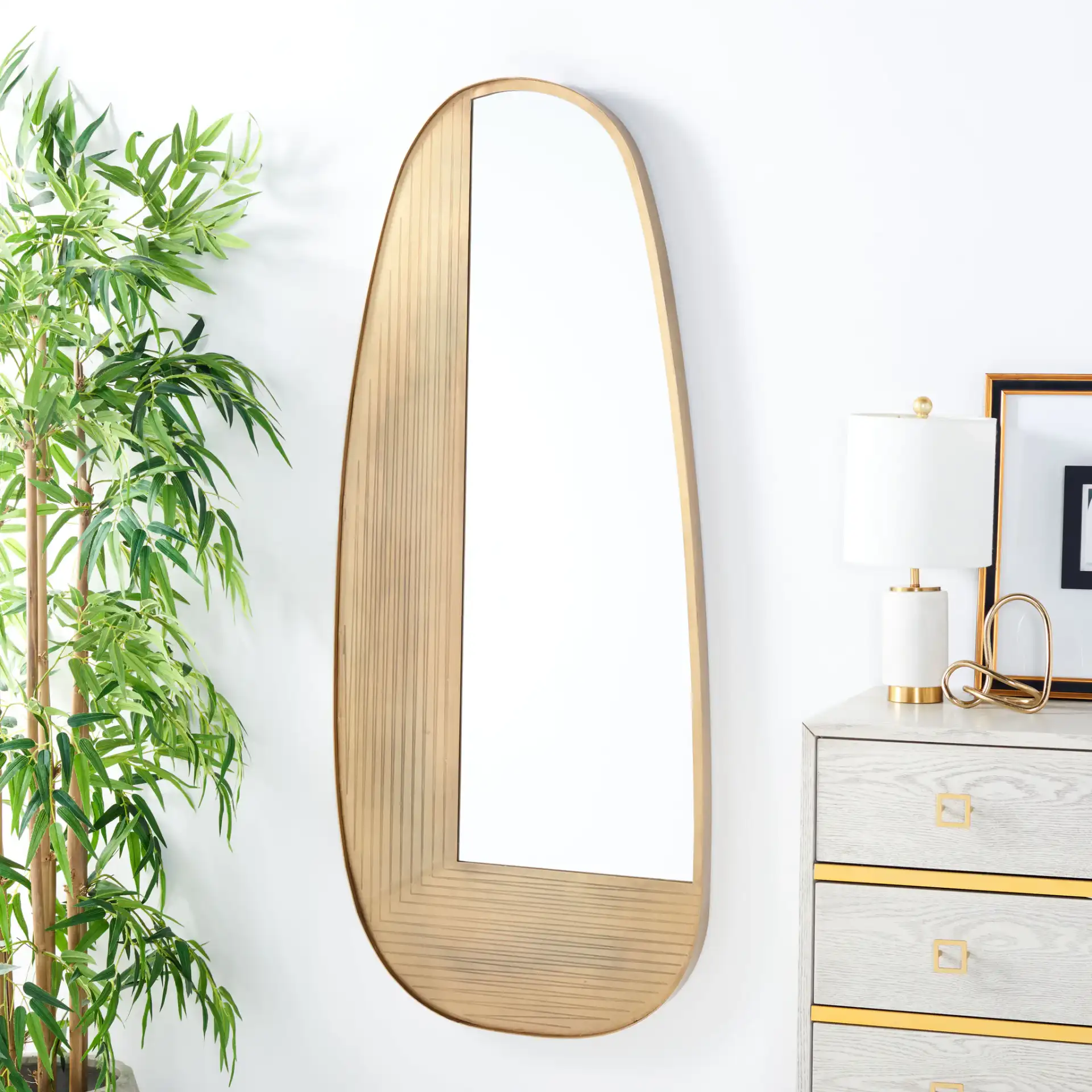 Kinselle 23-Inch Mirror in Antique Brass in a styled room