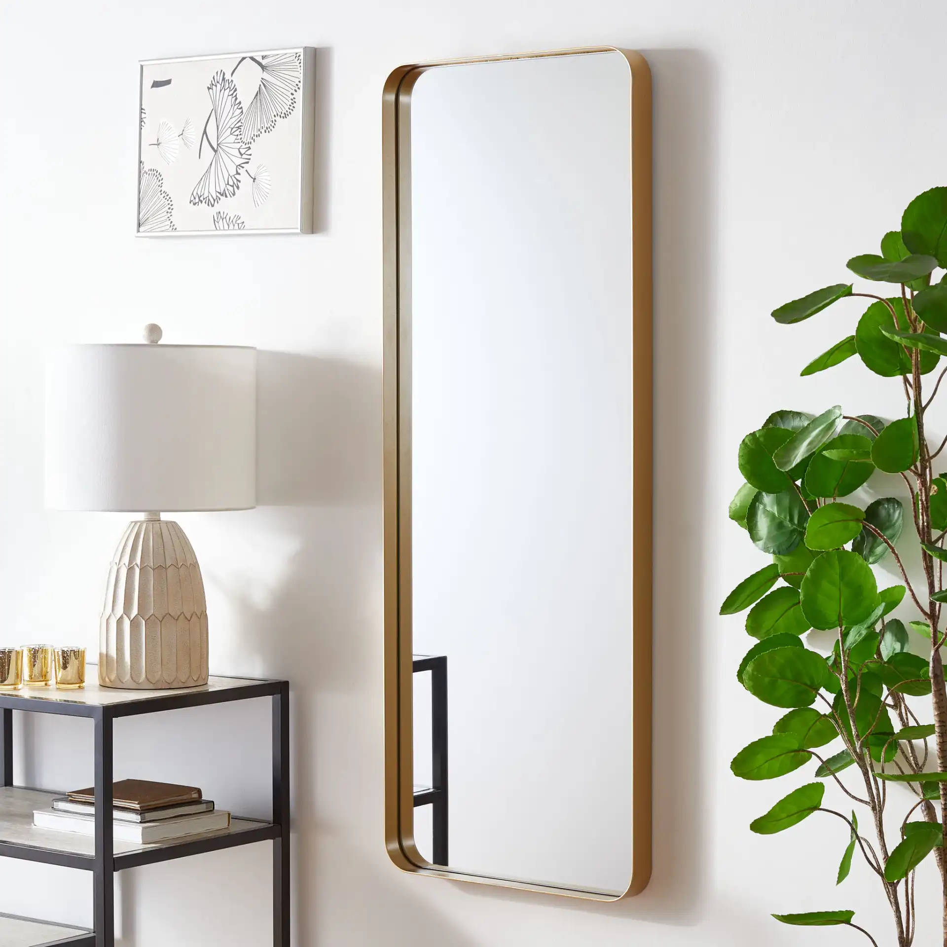 Almasy 18-Inch Mirror in Gold in a styled room