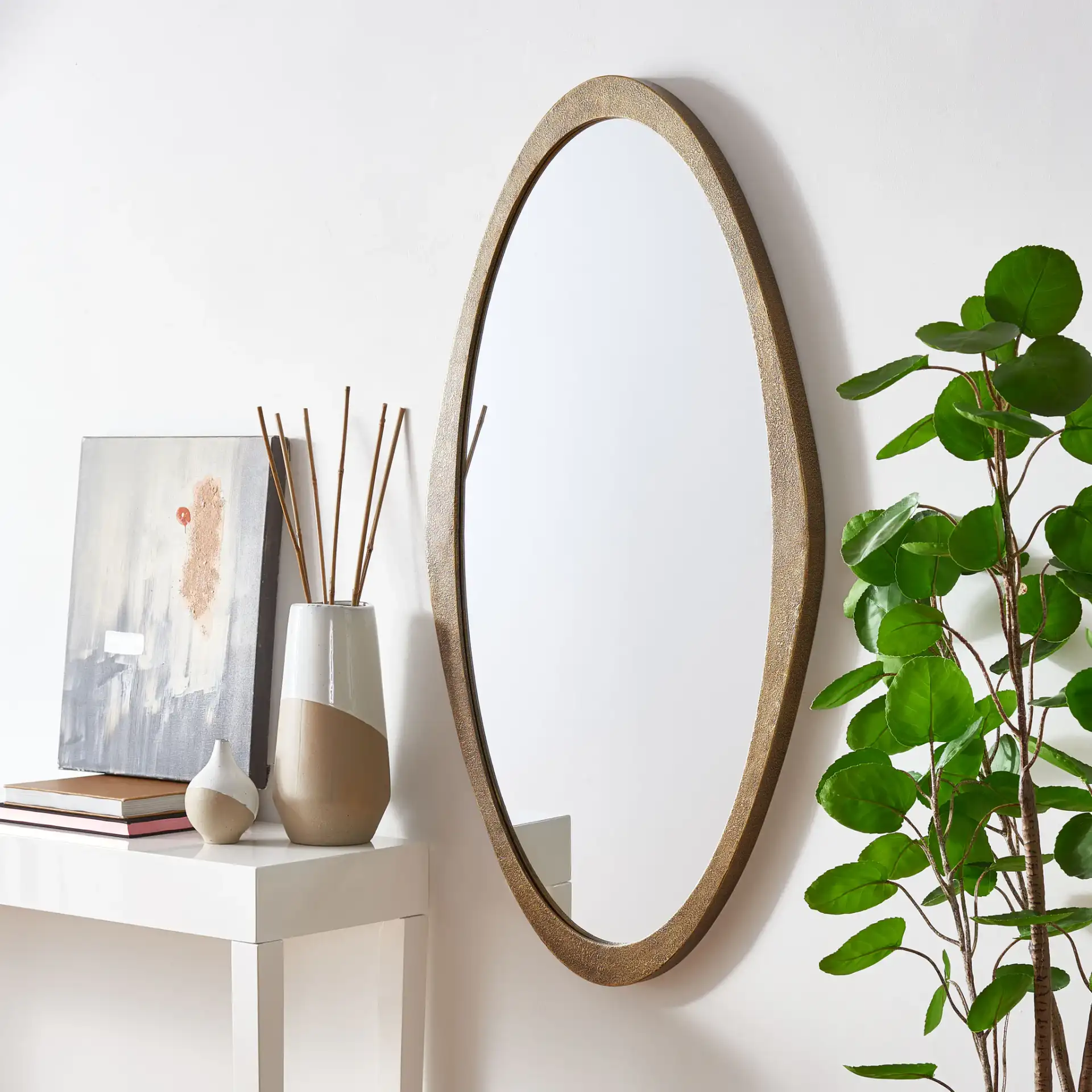 Cassini Mirror in Brass in a styled room