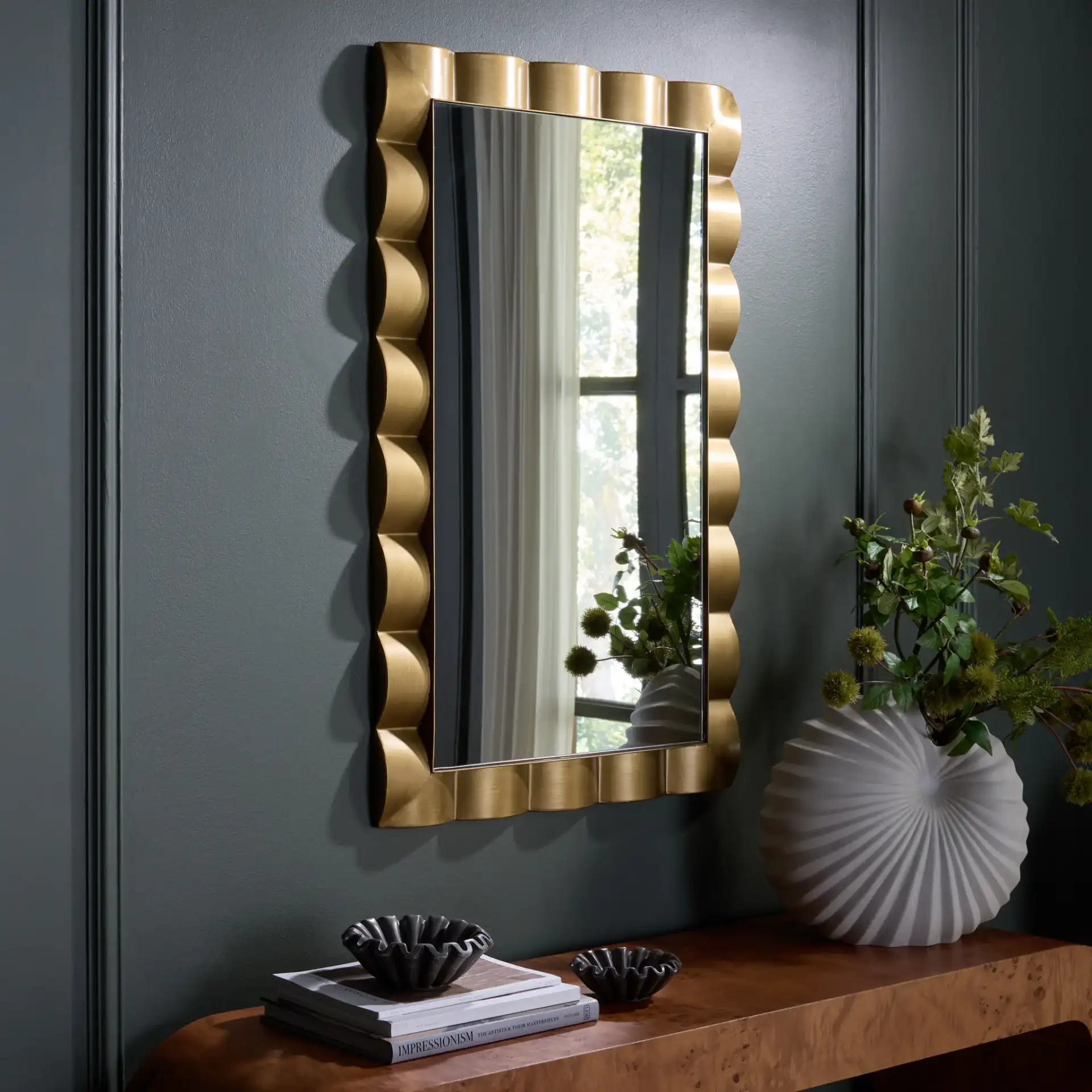 Nira Wall Mirror in Gold in a styled room
