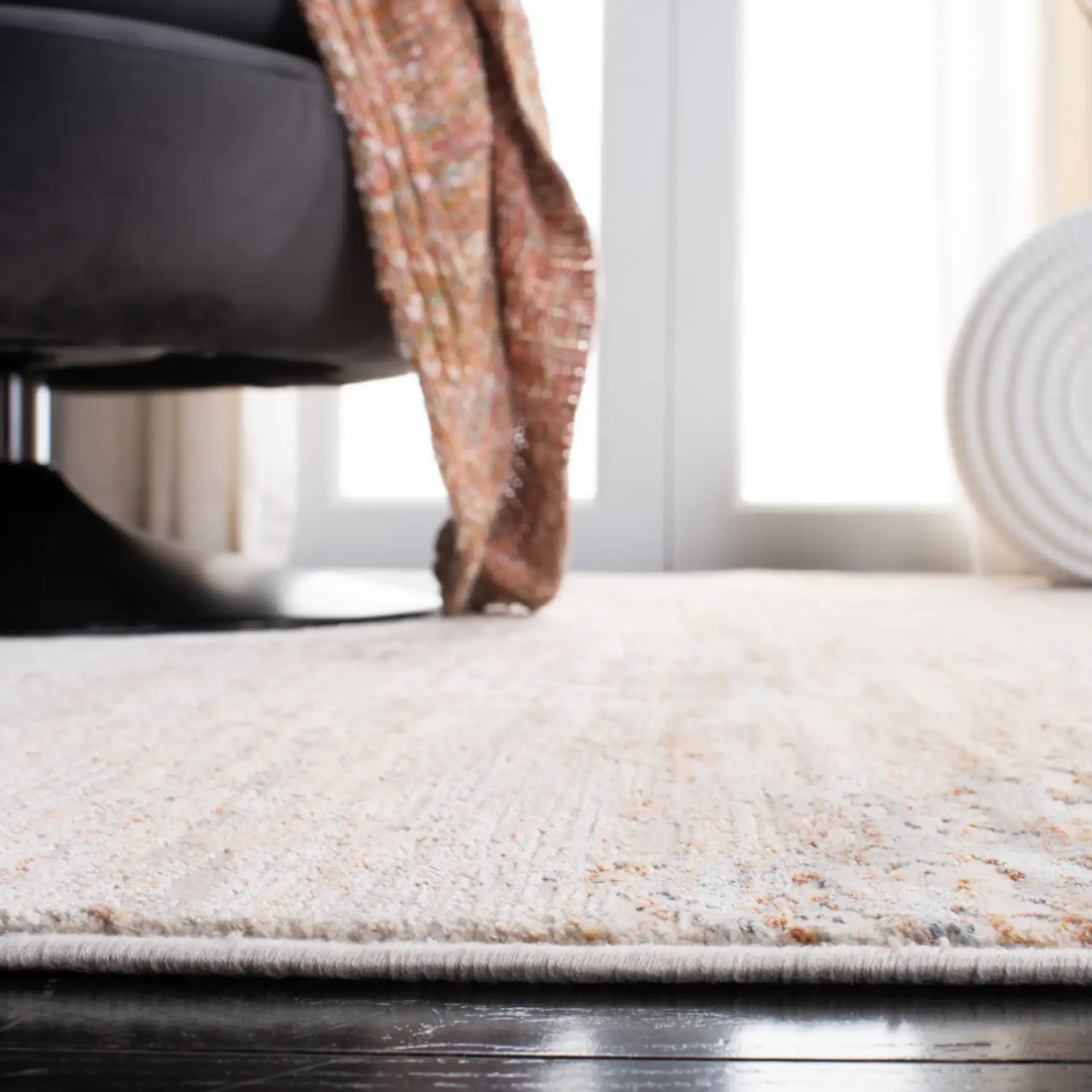 Marvel Striated Abstract Rug in Beige / Gold in a styled room