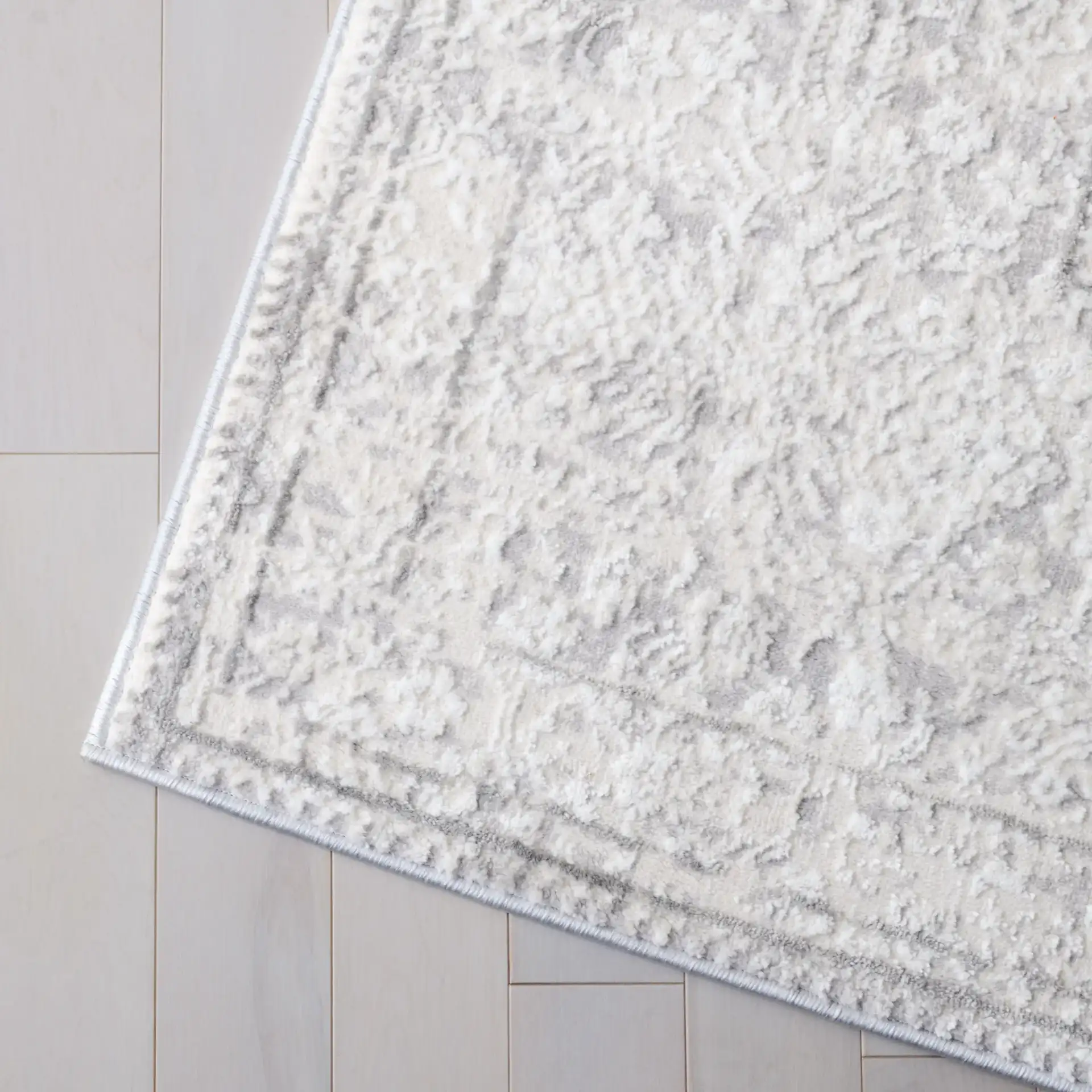 Martha Stewart Easton Distressed Medallion Rug in Ivory / Gray in a styled room
