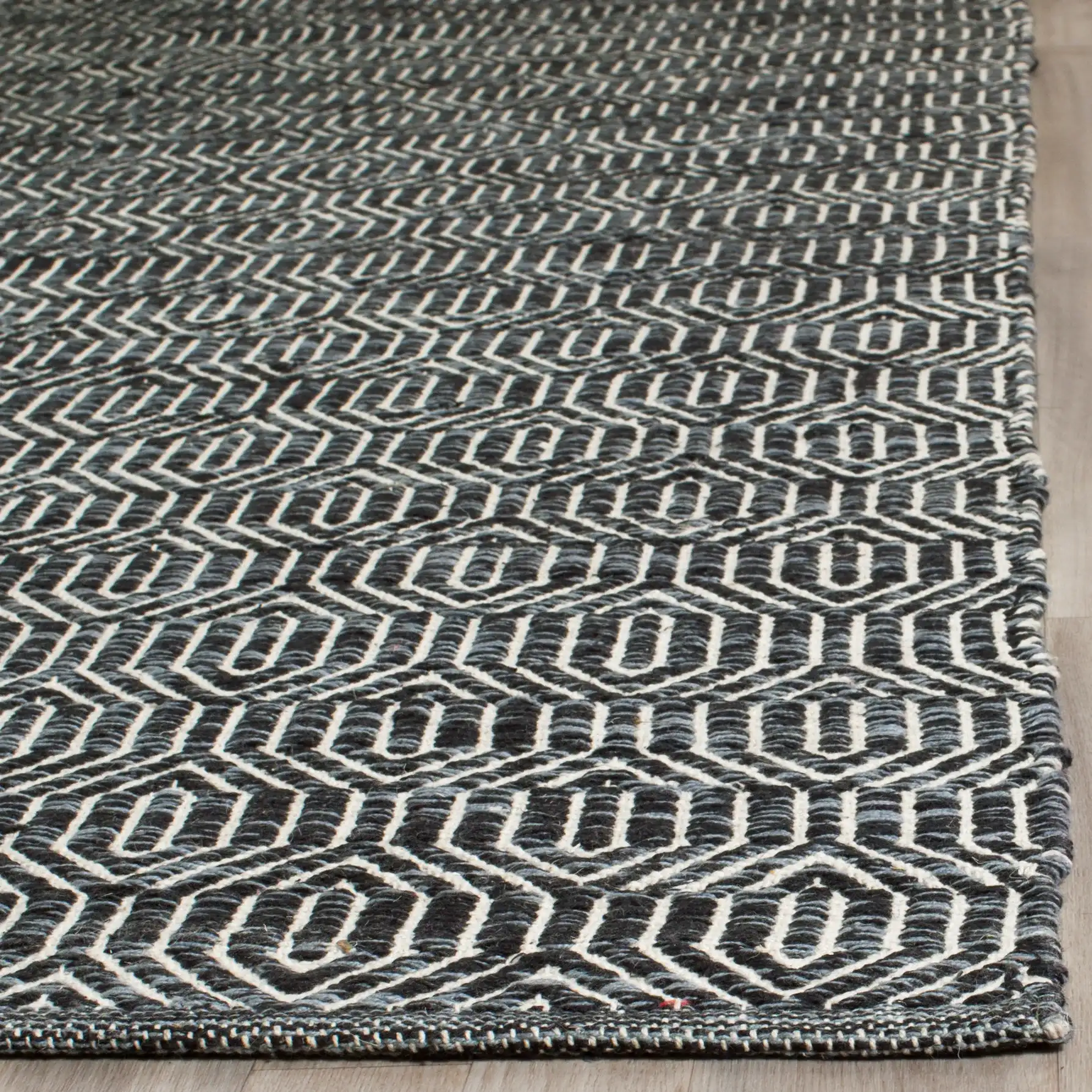 Montauk Nested Diamond Hand-Woven Cotton Rug in Ivory / Dark Gray in a styled room