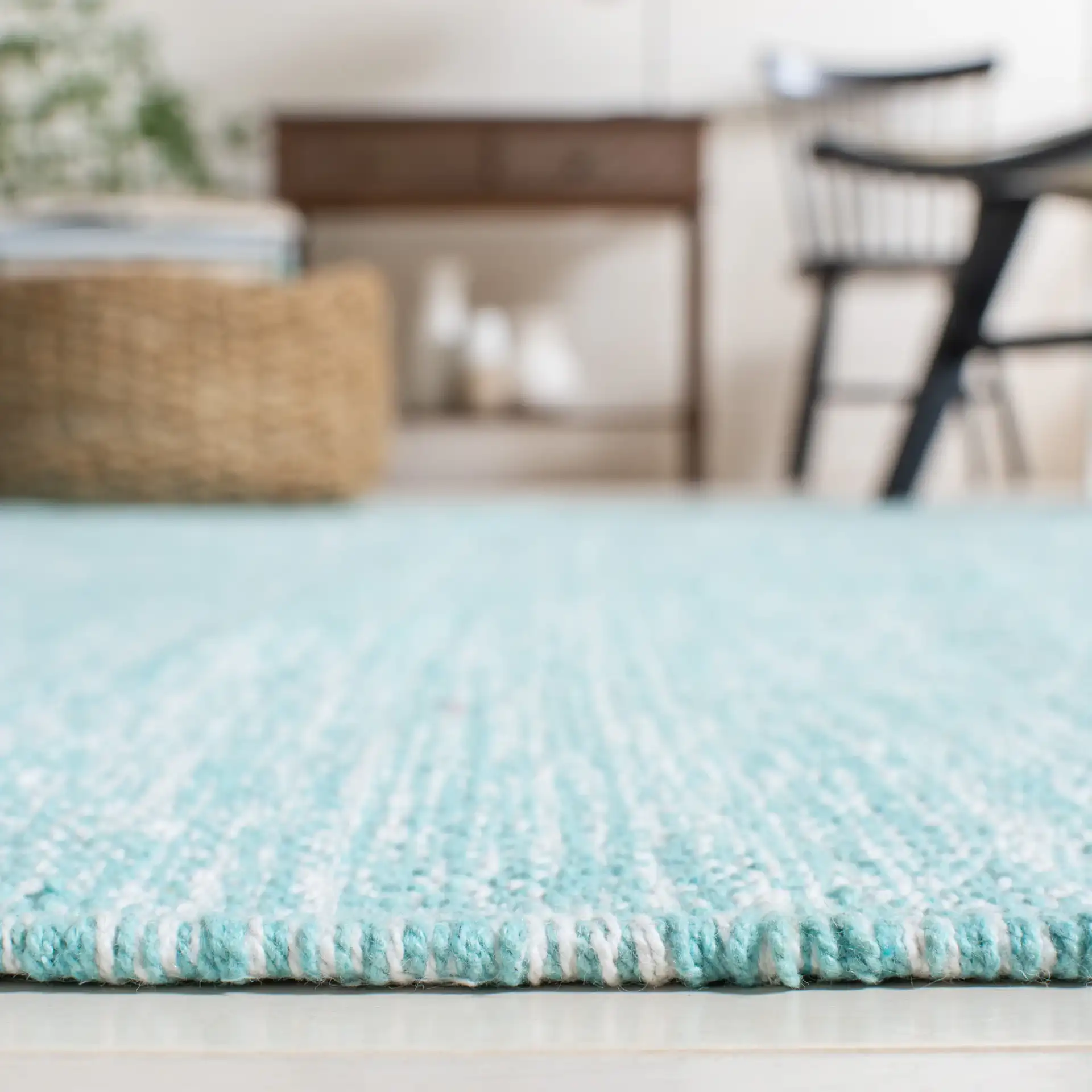 Montauk Scalloped Border Hand-Woven Cotton Rug in Turquoise in a styled room