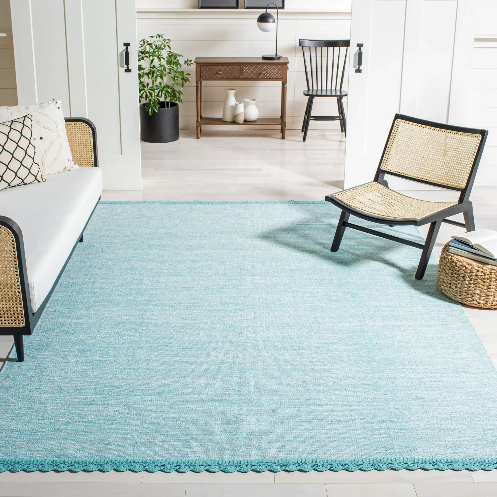 Montauk Scalloped Border Hand-Woven Cotton Rug in Turquoise in a styled room