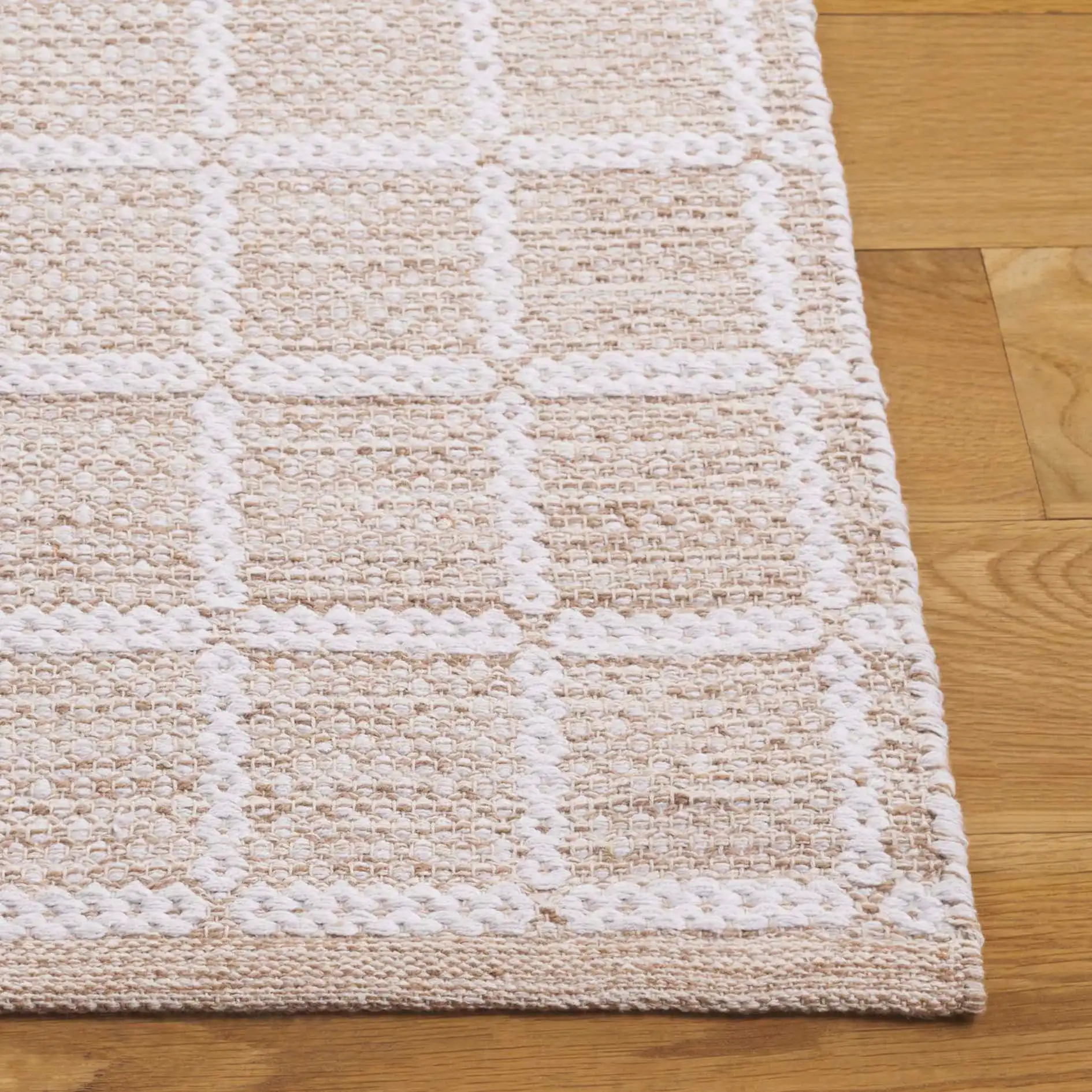 Montauk Waffle Grid Hand-Loomed Cotton Rug in Beige / Ivory in a styled room